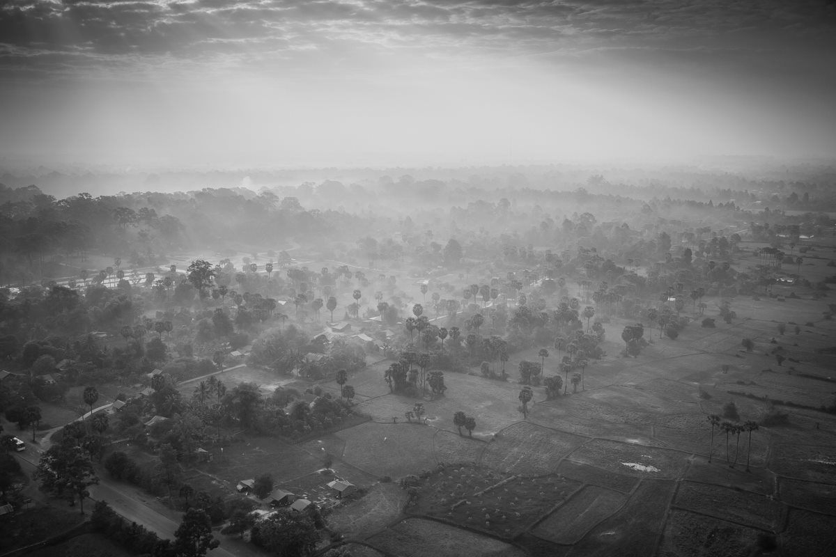 Steam rises off Siem Reap as a new day begins. Taken from an air balloon.