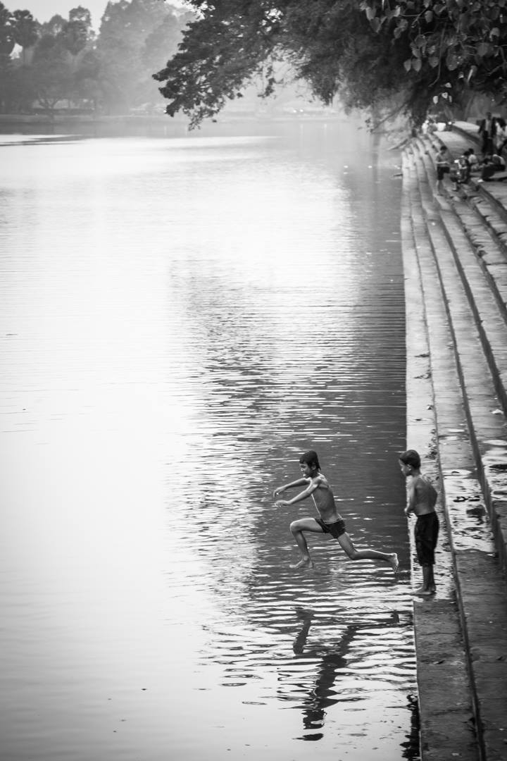 Youth playing as I cross the river at the entrance of the Angkor Wat temple.