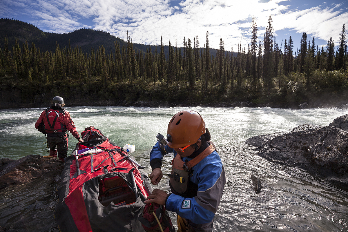 After line dragging the canoes past the Class V rapids known as ''The Step,'' paddlers check the gear for damage.