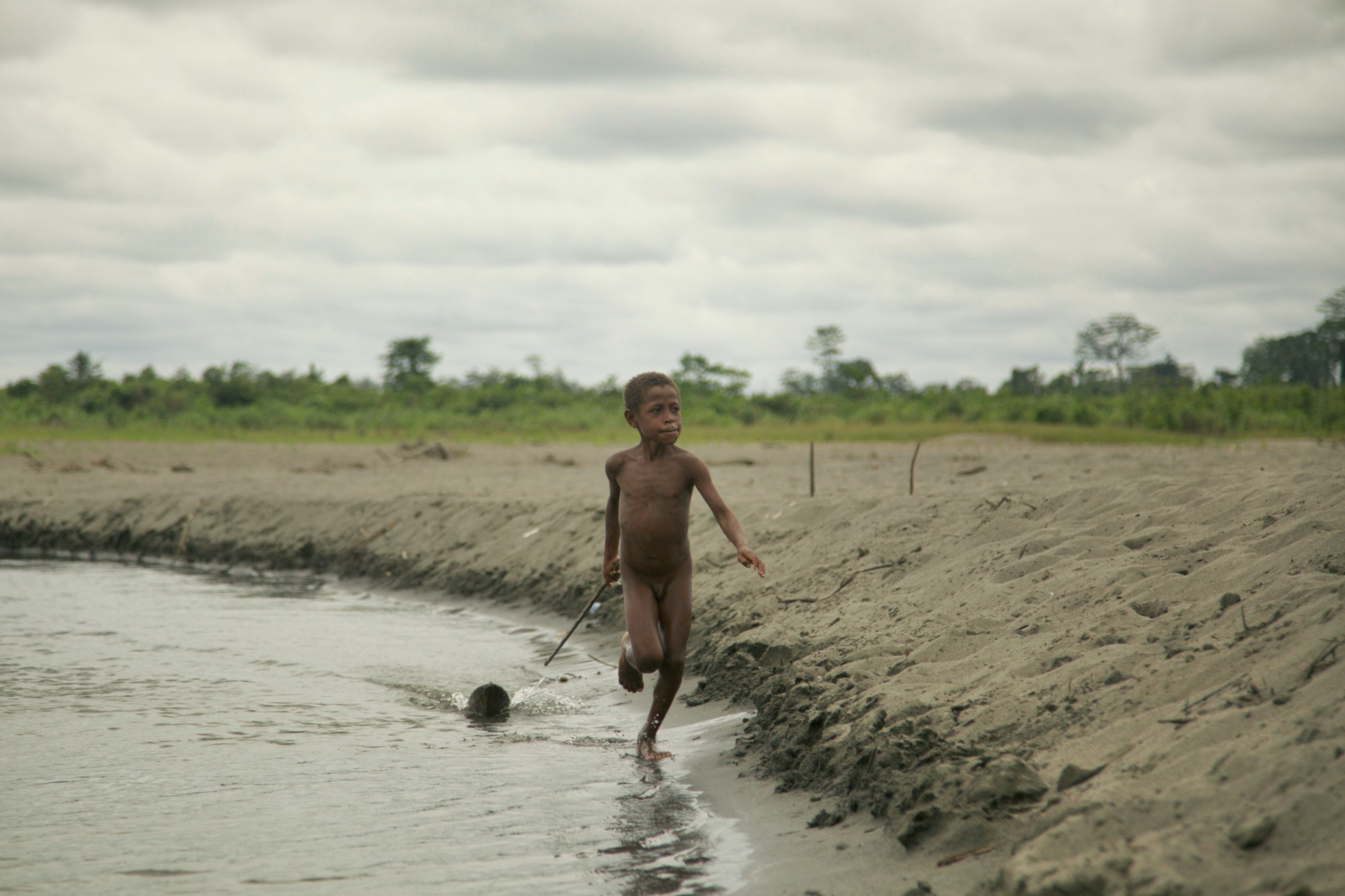 Korowai boy, moved with his family from the jungle to the river. Mobul village, West Papua