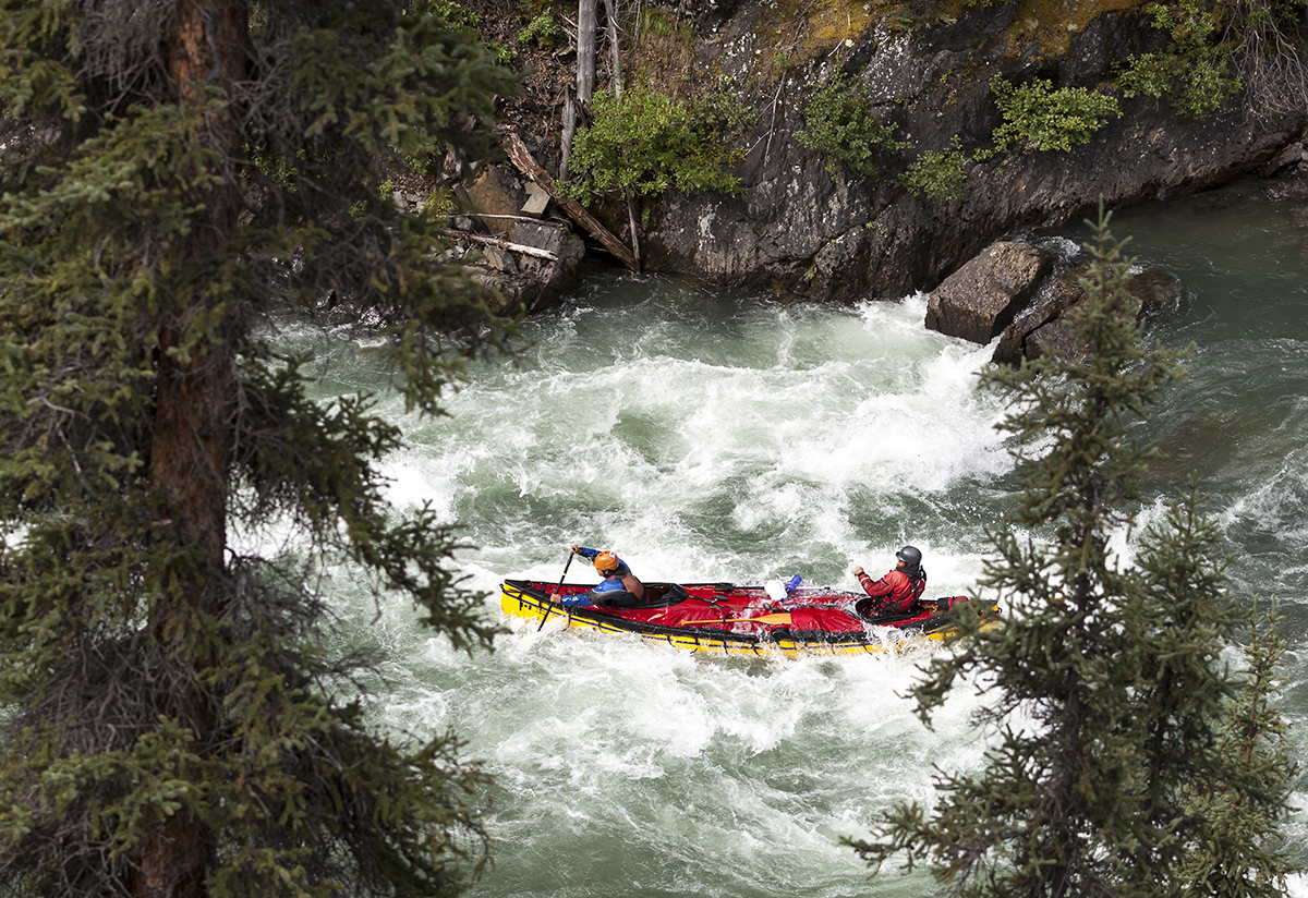 Paddling through the most difficult section of the 14 day adventure, a canoe barrels through ''Crooked Canyon.
