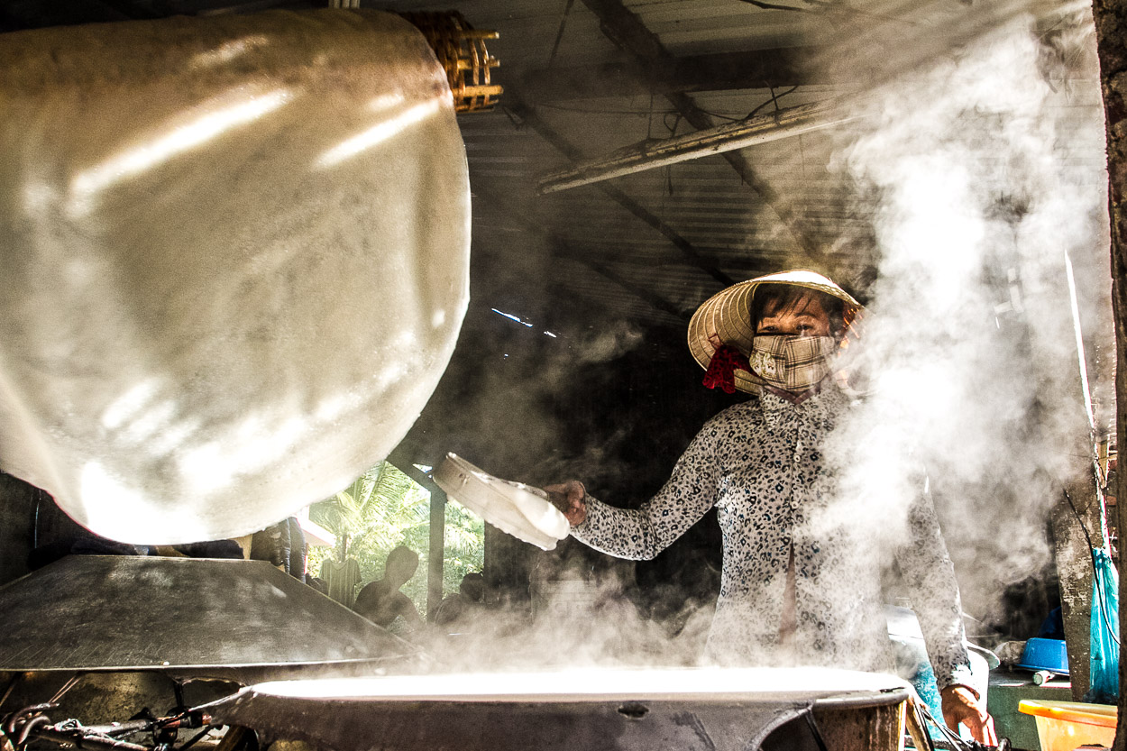 A Vietnamese woman working in a factory of rice noodles. Rice noodles production in the Can Tho city is important to the food supply in the country and national economy.