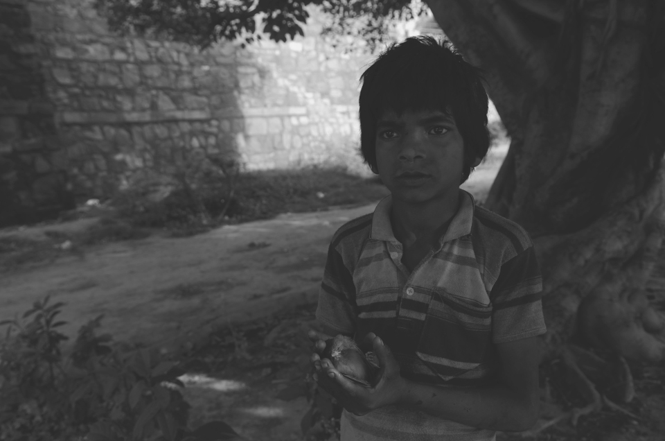 Poor street child caring for orphan bird