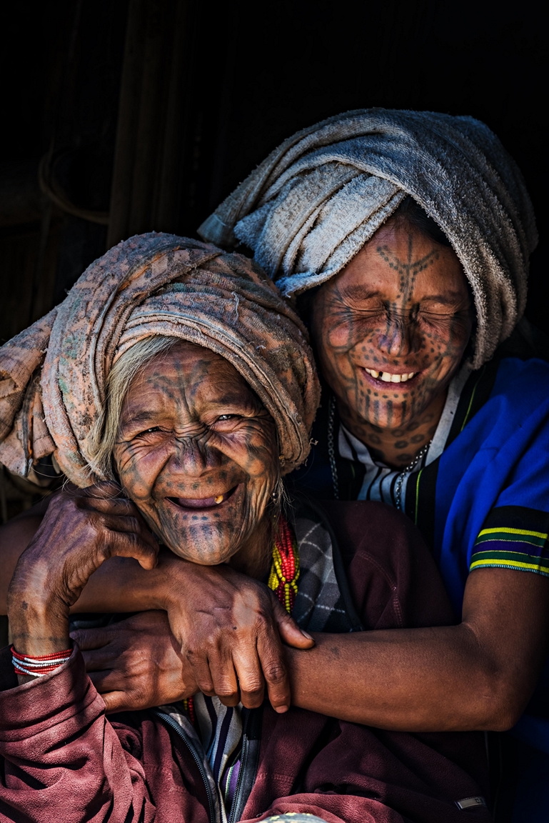 Tattoo-faced mother and her daughter having a great moment of happiness.