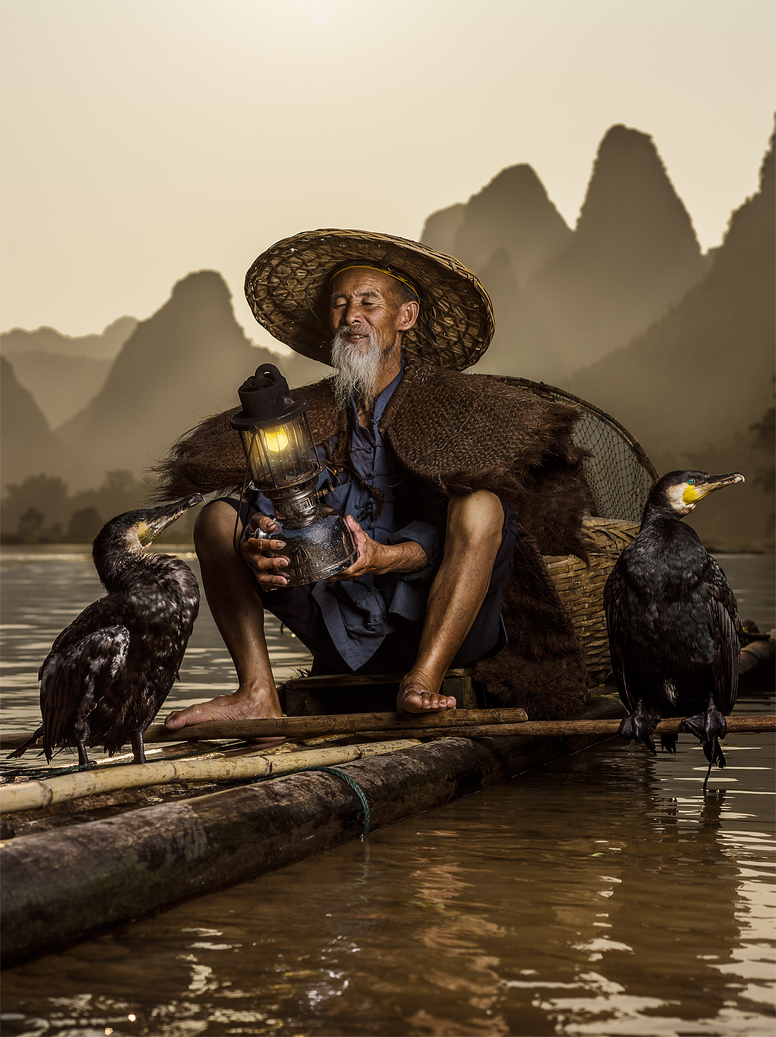 He cannot fish anymore for profit, so he has turned his life to the tourism, he offers his birds to pose for photos with chinese tourists who visit the area.