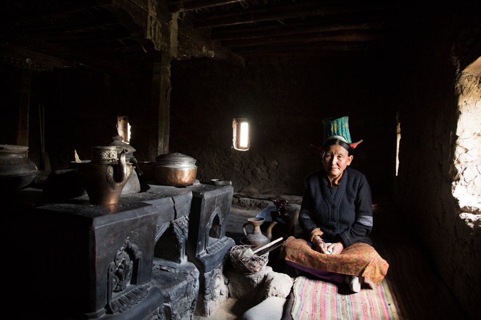 A ladakhi lady in her traditional  600 years old kitchen