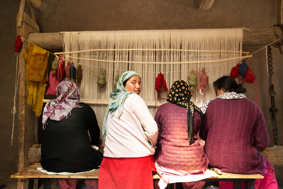 Lady weavers weaving in the break of day