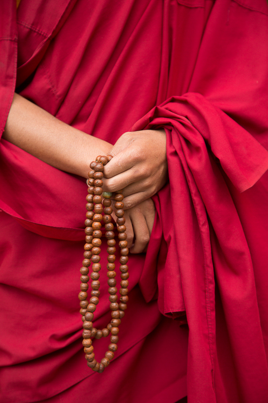 A monk's hands with prayer beads.