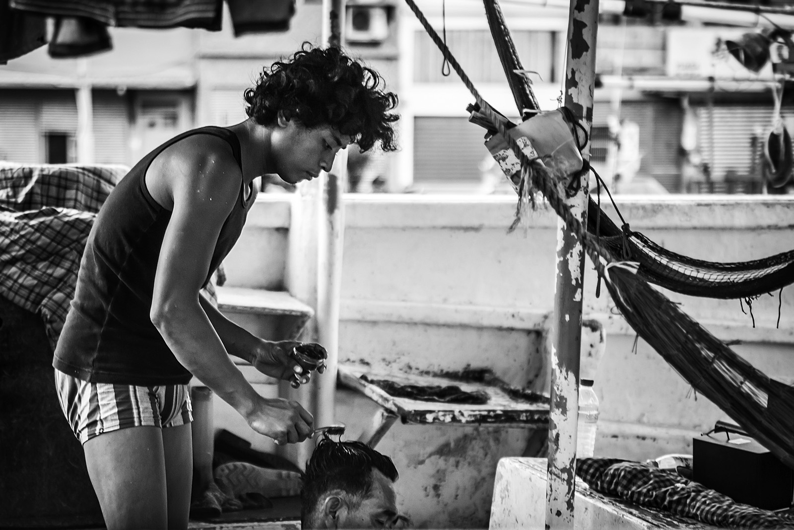 Fishermen in Nanfang-Ao, Taiwan end their day by styling each other's hair. They live their lives on the boats, where they eat and sleep, at sea and in port.