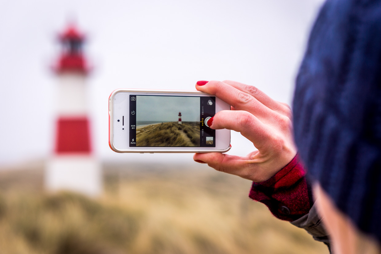 Selfies and snapshots. The lighthouse is stunning any way you look at it. It's imposing structure stands resolute against the raging wind and waves lapping in the distance.