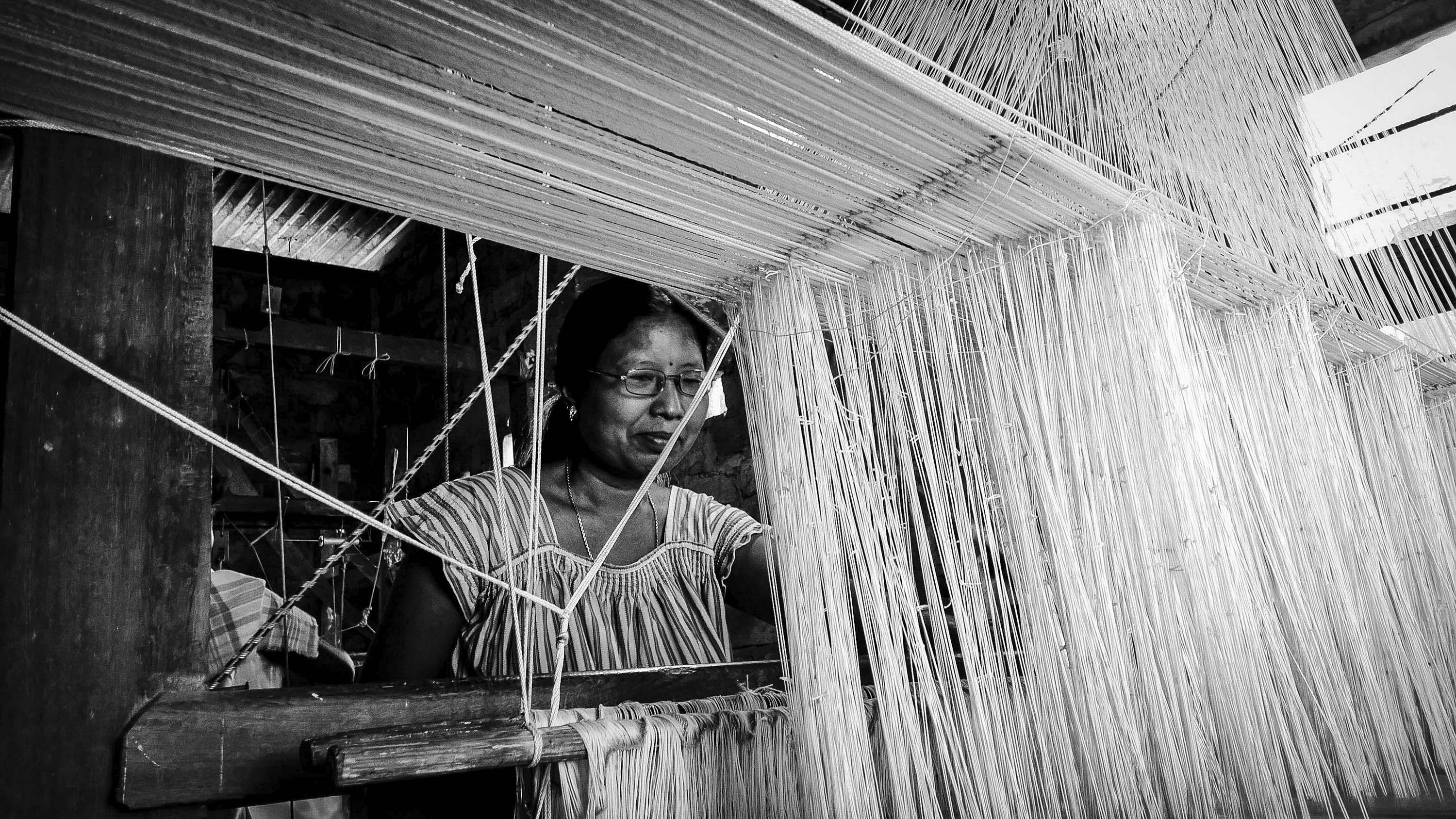 Sharmila, a cancer survivor and a fighter happily immerses herself in the set creating fine quality of Muga Silk, a traditional Assamese costume. She fled her village and came to Kamrup in search of better medical facility and livelihood. Her indomitable courage has given motivation to many women working in the sets and nearby.