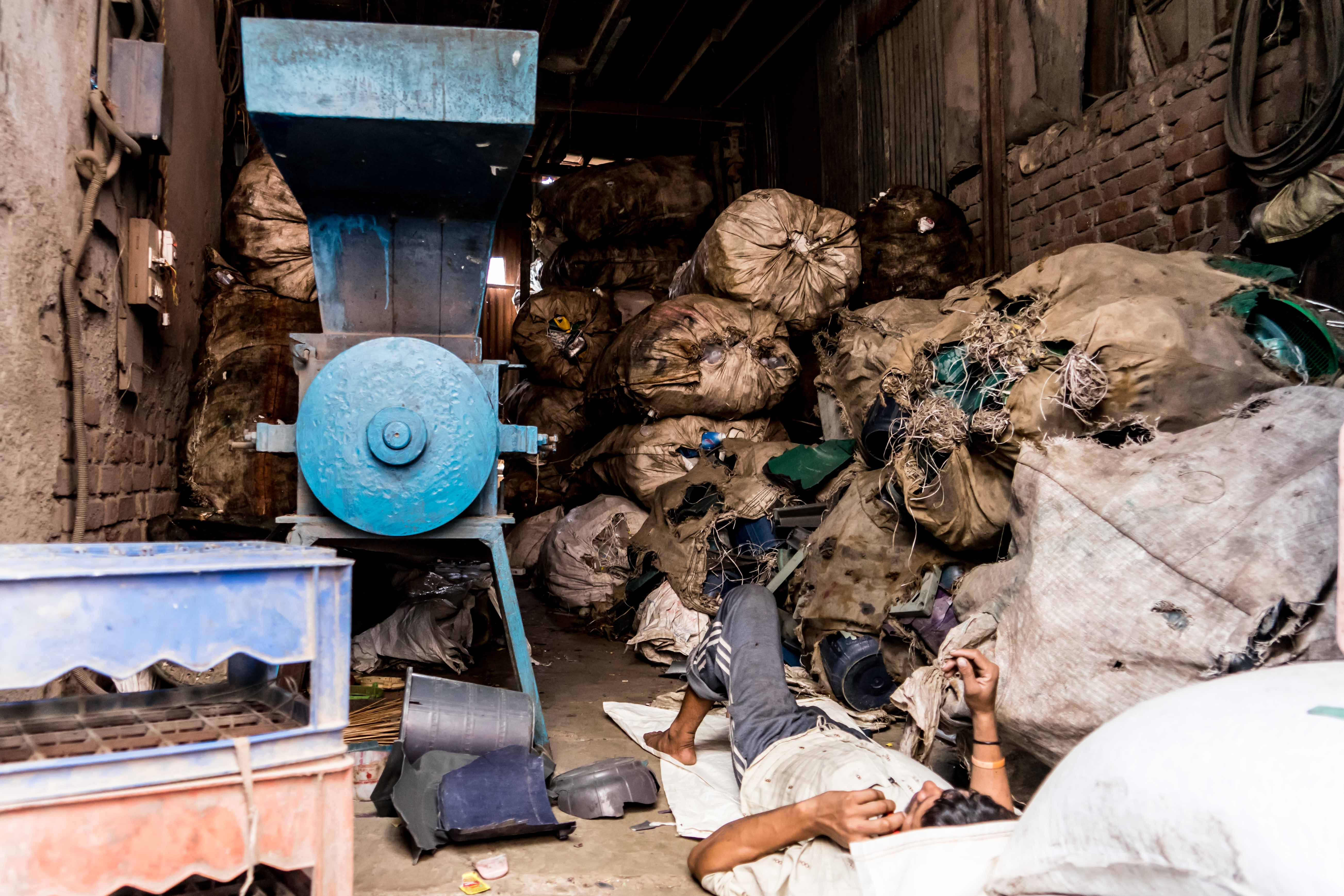 A plastic recycling worker resting