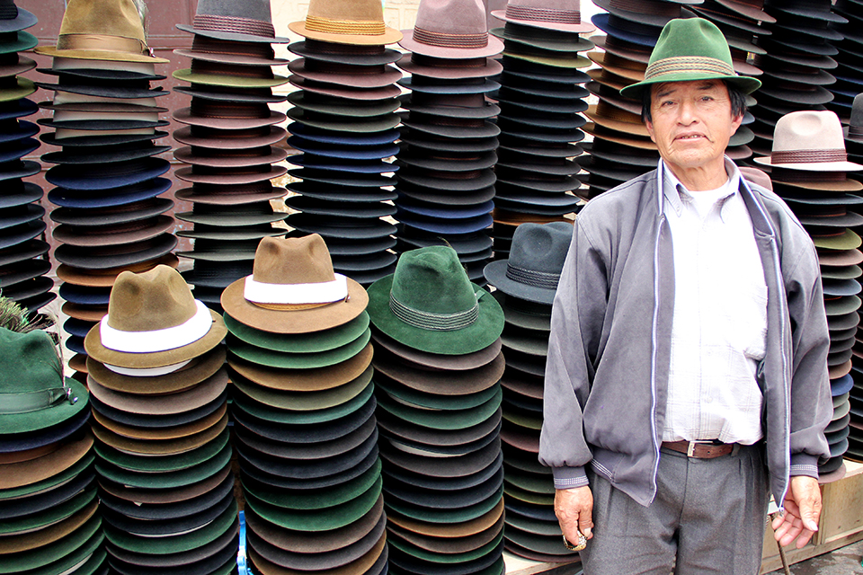 Lord of hats. A man in his family business. Hats are so used in the highland to protection from the equatorial sun, they avoid sun's damaging effects.