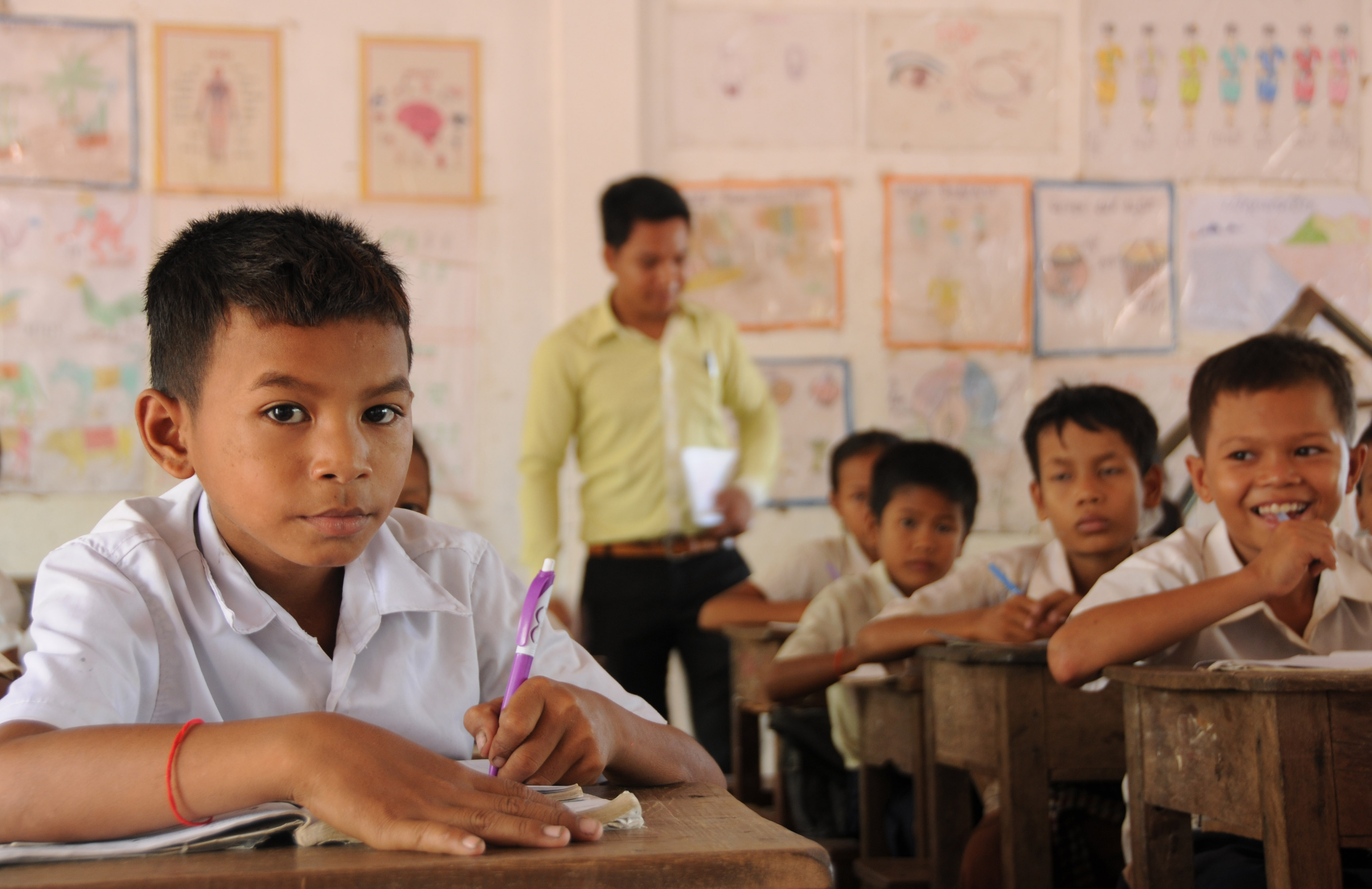 Nary's younger brother is in his classroom at grade six under the supporting from his sacrificing older sister of her schooling and his father to work on the construction site in a rural area of Siem Reap province.