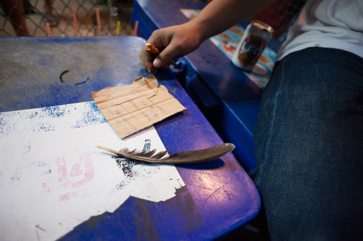 Chatuchak Weekend Market, Bangkok, Thailand 2012 A close up of a betting note and a cock's feather. Cockfighting is technically illegal in Thailand but in reality it is tolerated by the official government and is a very lucrative business.