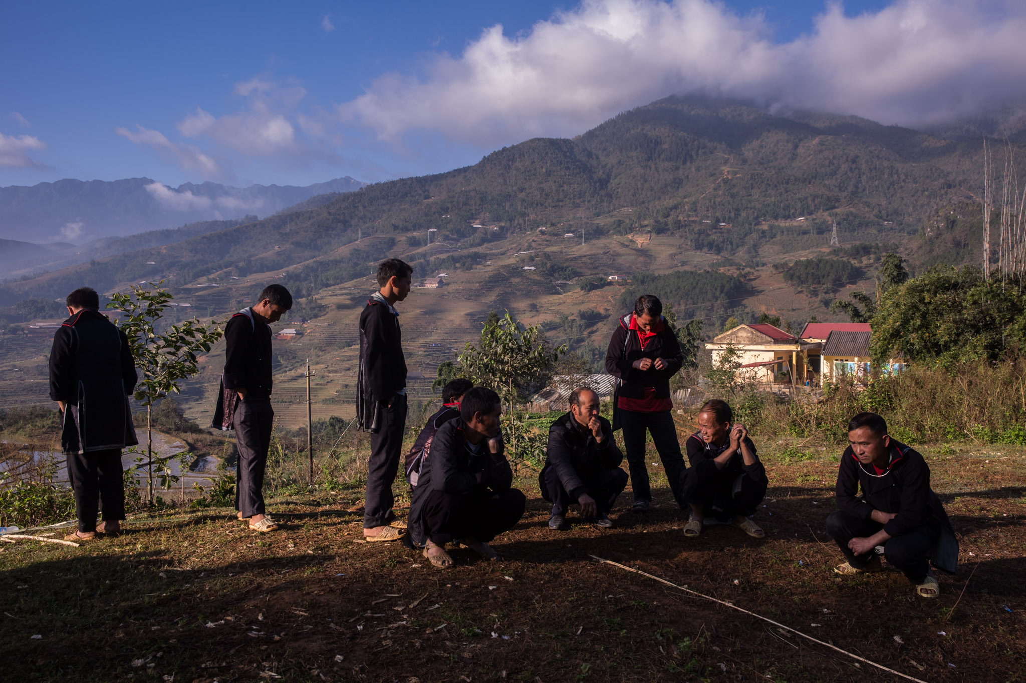 Men of the Hmong tribe meet in the early hours of the morning to begin the funeral rituals of one of the members of their community. Rituals around Hmong funerals are related to his deep belief in the reincarnation of the human soul.
