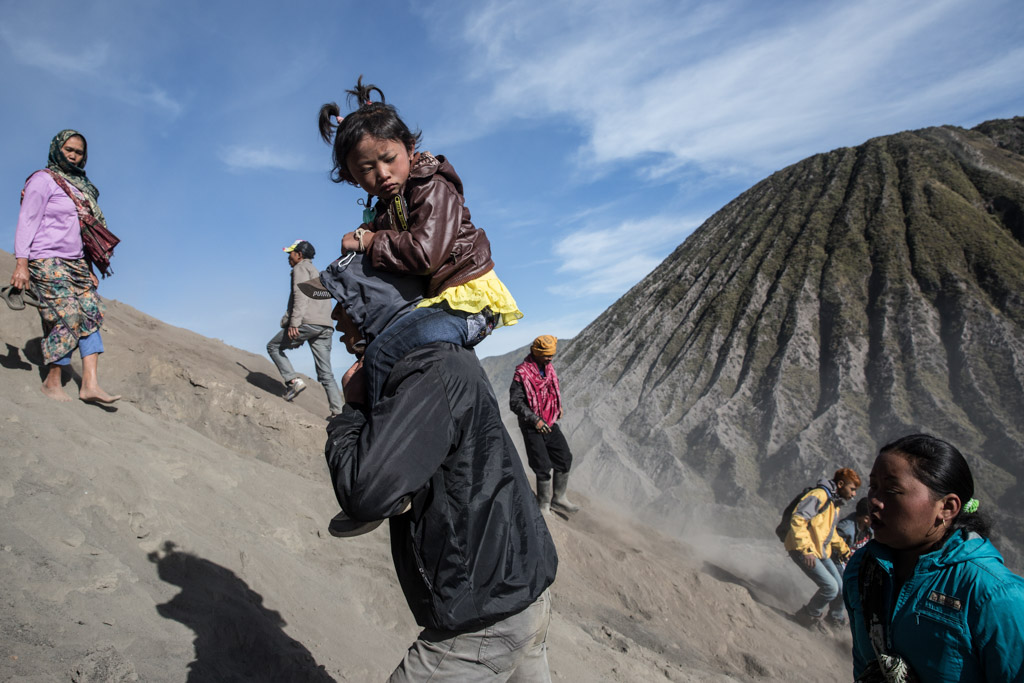 Tenggerese worshippers trek across the 'Sea of Sand' to give their offerings to Mount Bromo during the Yadnya Kasada Festival at crater of Mount Bromo, Probolinggo, Java, Indonesia.