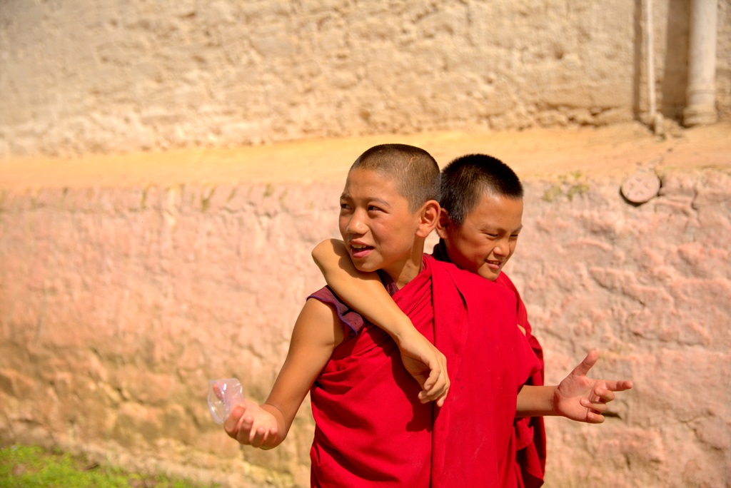 Two young monks were relaxing and strolling, before the inaugural bells of the Dzong started ringing loudly.