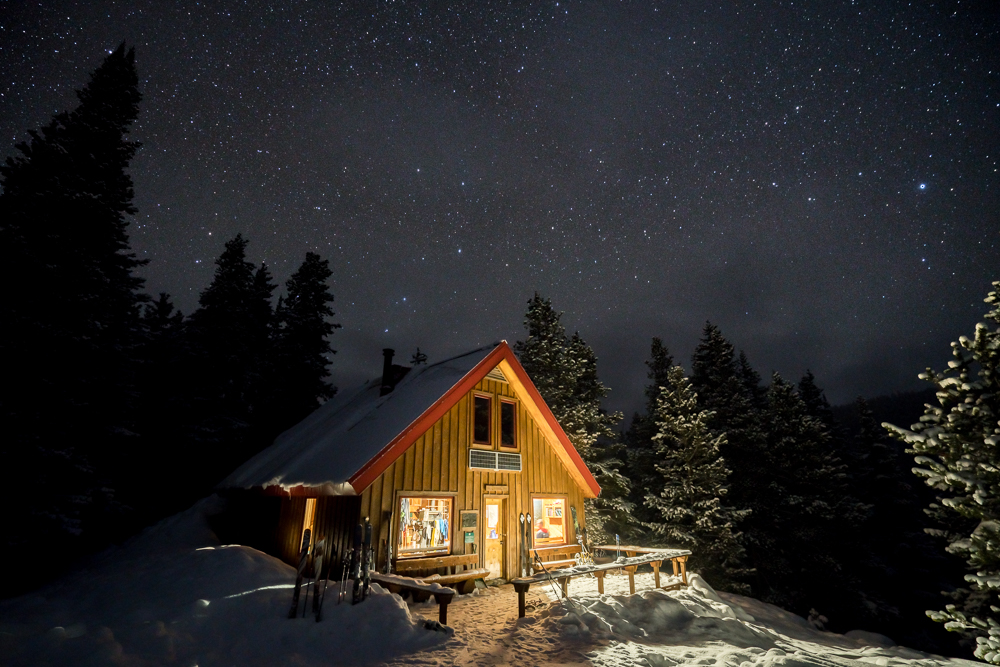 McNamara Hut high in the backcountry of Aspen under a blanket of stars and new snow. Reaching this cabin required a day of ski-touring from town along snow covered roads and trail.