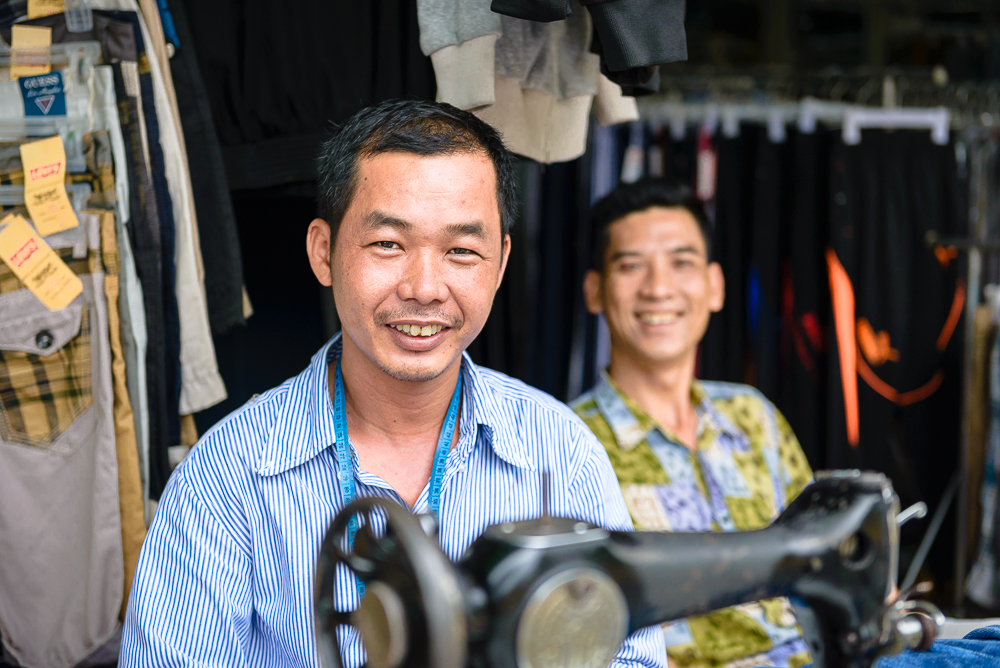 The tailor of Saigon spends his days working his ancient machine to repair clothing for those who cannot afford to buy new.