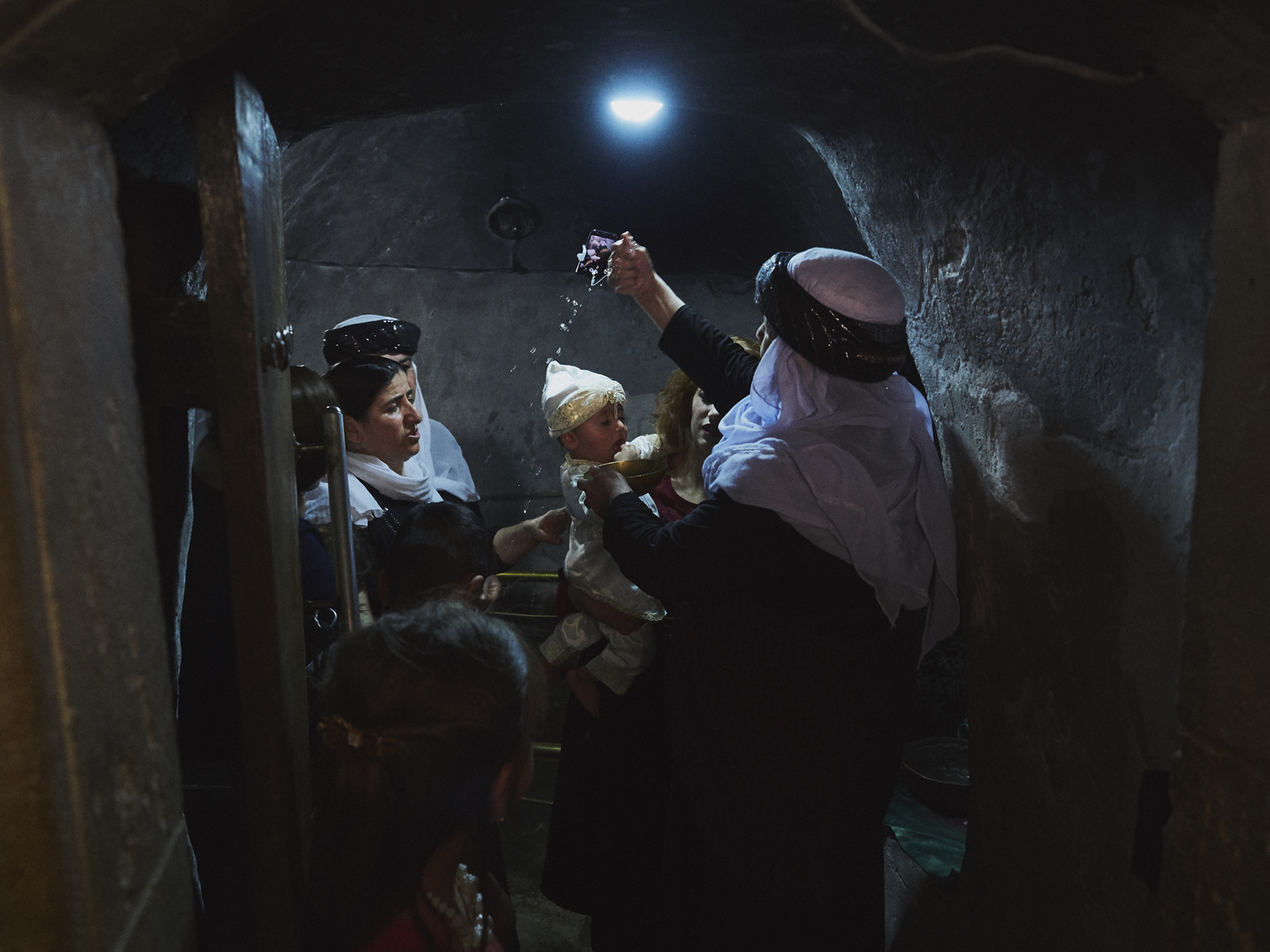 Lalish, Northern Iraq. Yazidi families are expected to baptise their children within the first two years of their lives. The generation of children brought to Lalish for the ceremony were born following the genocide, and are thought to represent the community's hopes for a more peaceful future.