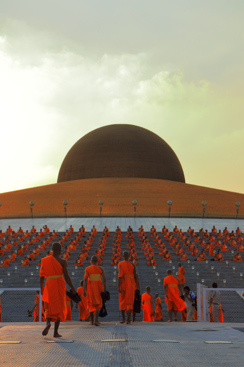 As the sun sets, monks settle into position for one of the world’s largest gatherings.