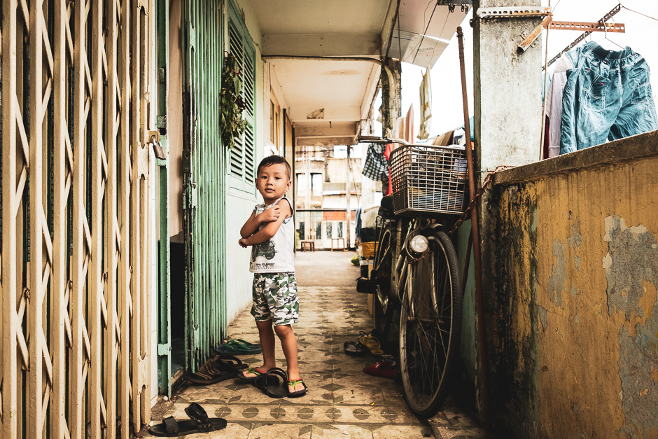 Corridors of Life. Cramped, dark apartments, monsoon-stained walls with peeling paint, an uncertain future, and all other odds are trumped by the sense of community and kinship displayed by the residents of the old housing blocks of District 3, Saigon.