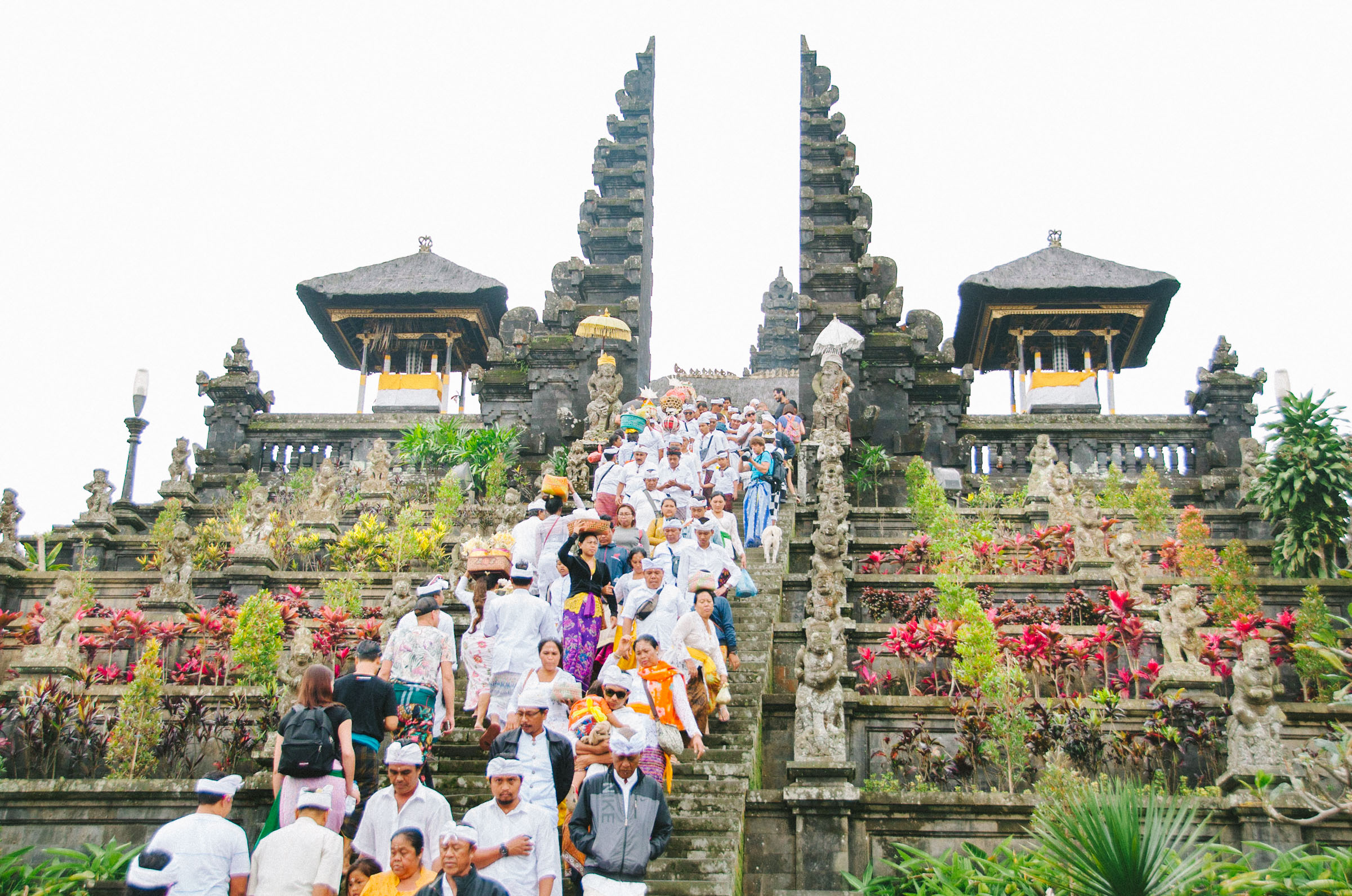 Balinese people making their way back down the stairs of Besakih Temple, known as Bali's 'Mother Temple' after attending the blessing ceremony. The complex is over 1.000 years old and is Bali's biggest and holiest temple.