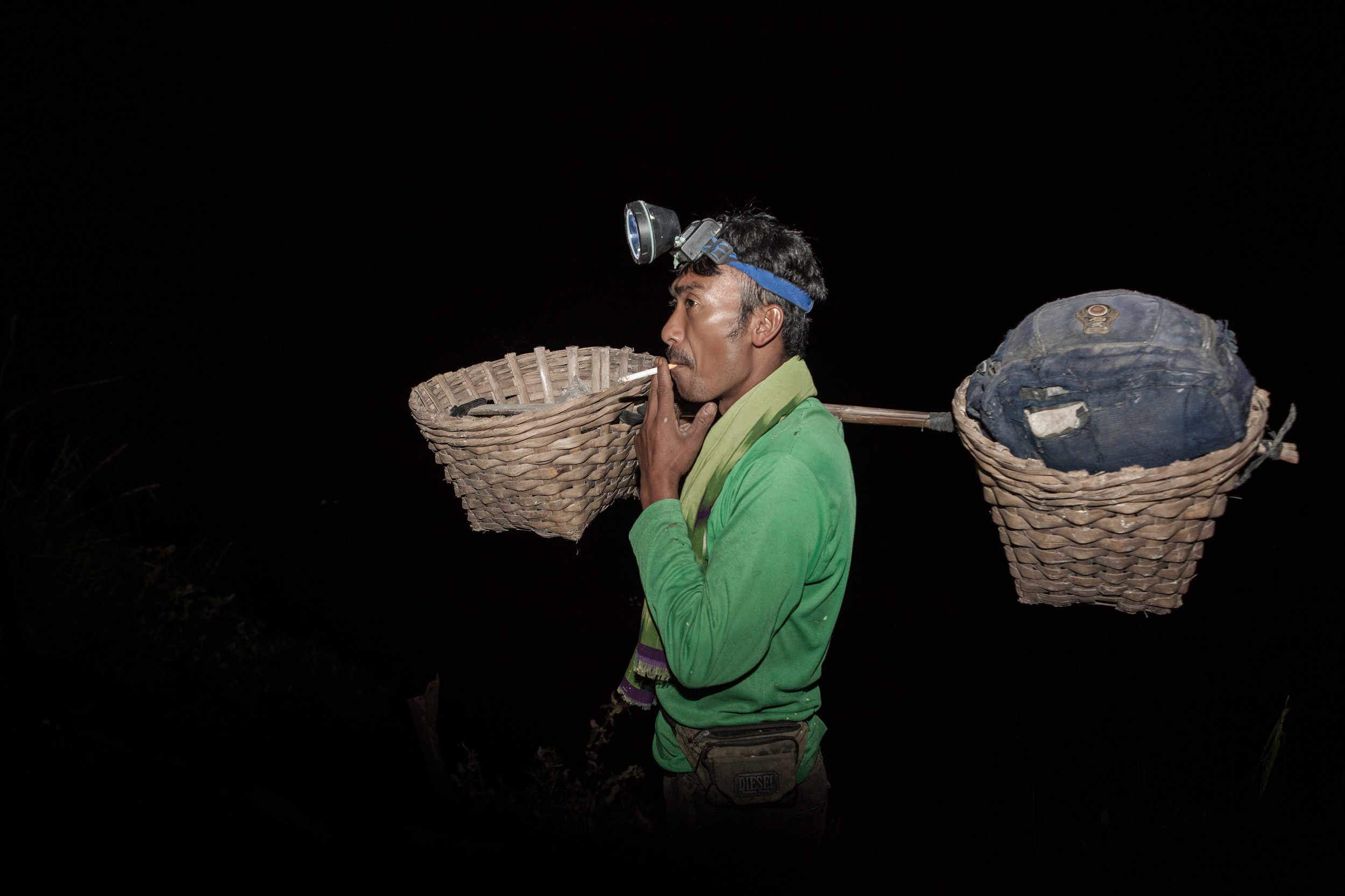 The miners trek to the crater at night. It takes them over an hour to reach the summit of the volcano, then another hour to descend inside the crater, where they mine sulfur.