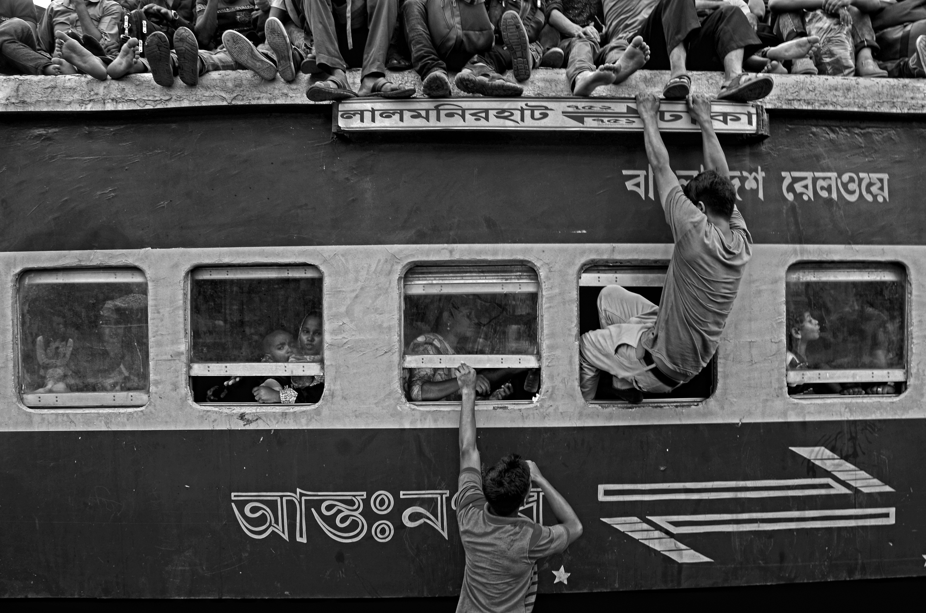 When the train are overloaded including roof , the passengers want to take a place in train by entering into the window. They want to reach their home at any cost.