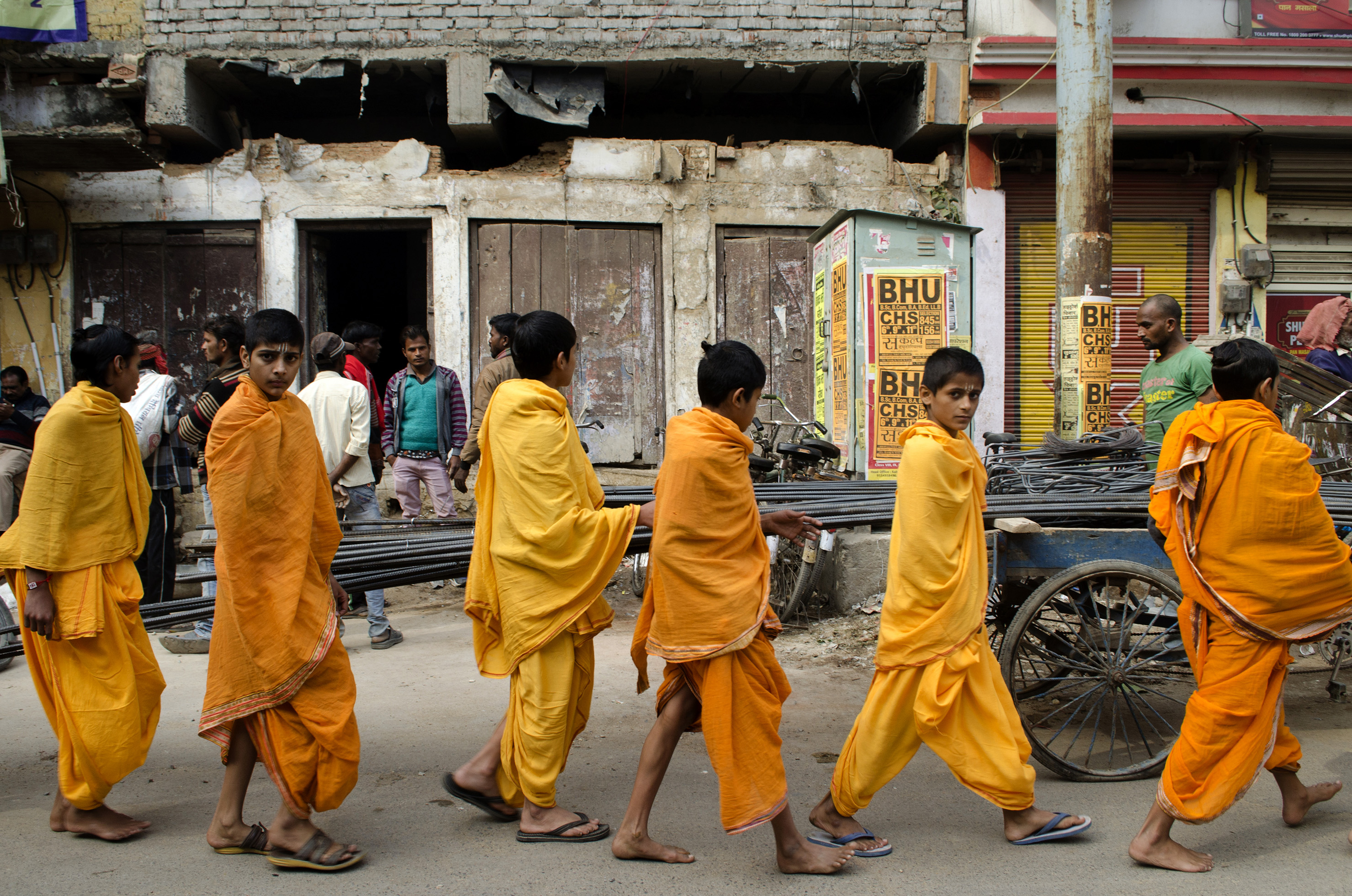 The devotion of the young pilgrims to become priests. Kids walking in the chaotic city of Varanasi.