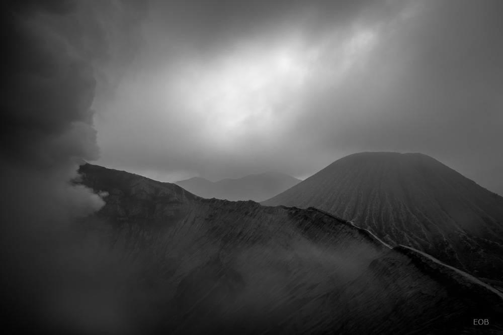 Summit of Mount Bromo Volcano Indonesia. The fog and the suffer smoke the left work together resulting in a misty mood. The Triangle (volcano) and circle (crater)complement the composition