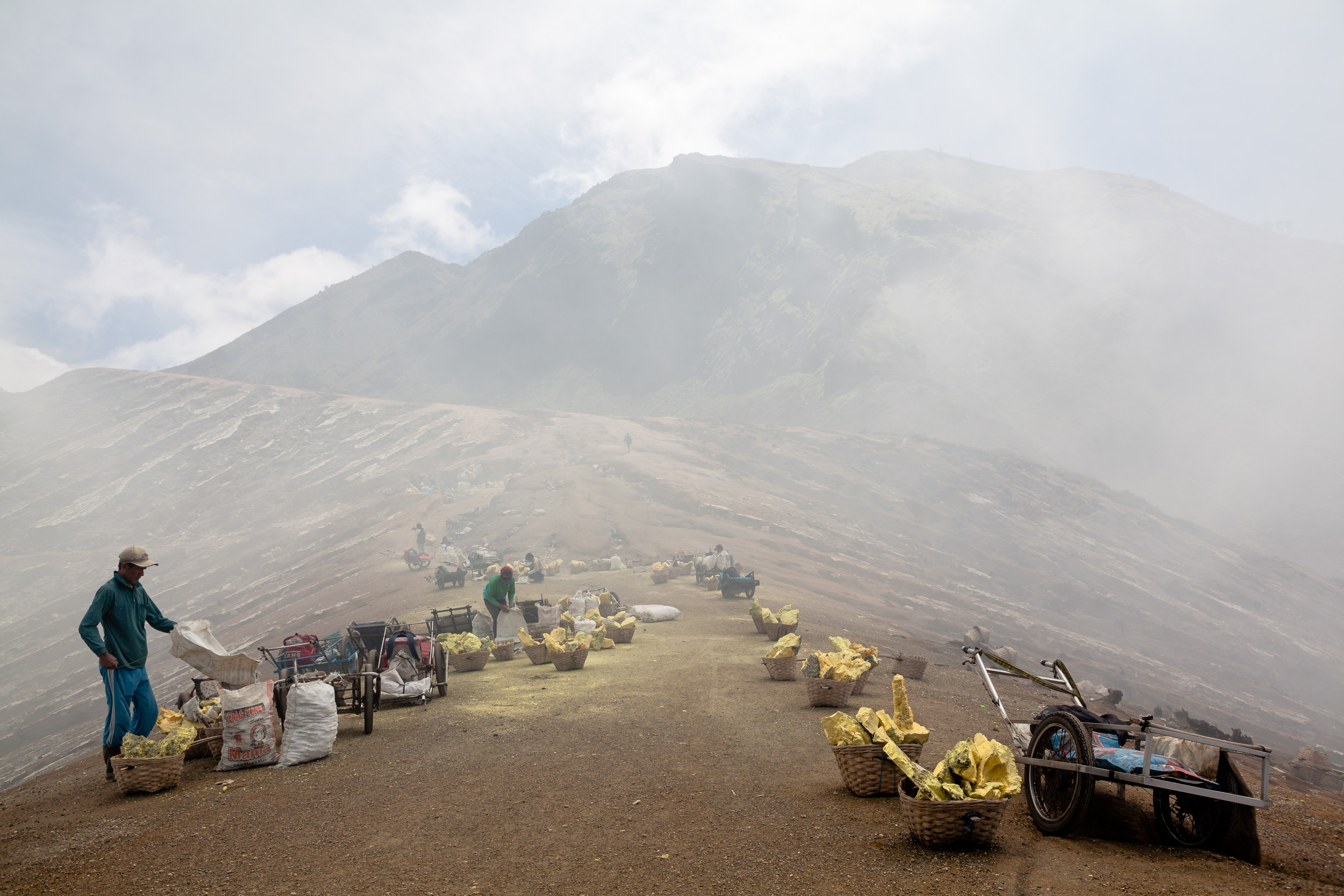 The peak of Kawah Ijen. This is where the miners’ sufferance ends – temporarily –. From here, the loads of sulfur are carried down the slope on two wheels hand carts. The miners do the exhausting trip twice per day, for a ridiculous amount of money.
