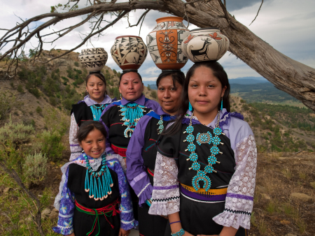 As monsoonal clouds gather over the southern Colorado plateau, the Zuni women proudly display the costumes and pottery of their culture that has existed here continuously for thousands of years.  Seven year old Jasmine will dance with them as soon as she can balance a pot on her head.