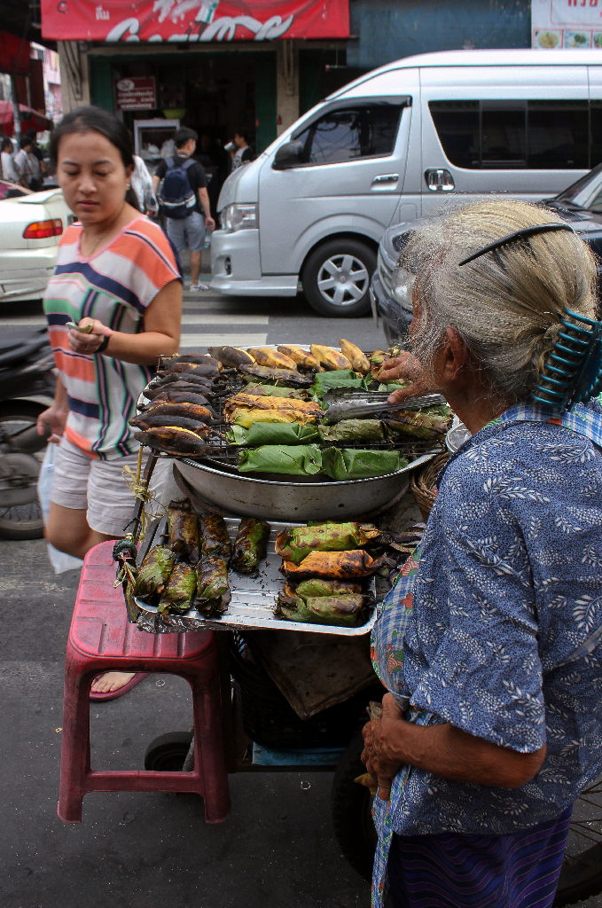 Shortly after snapping this shot, I devoured this sweet woman’s concoction on a neighborhood street in Bangkok. The steamed banana leaves encompassed a warm blend of nuts and rice.