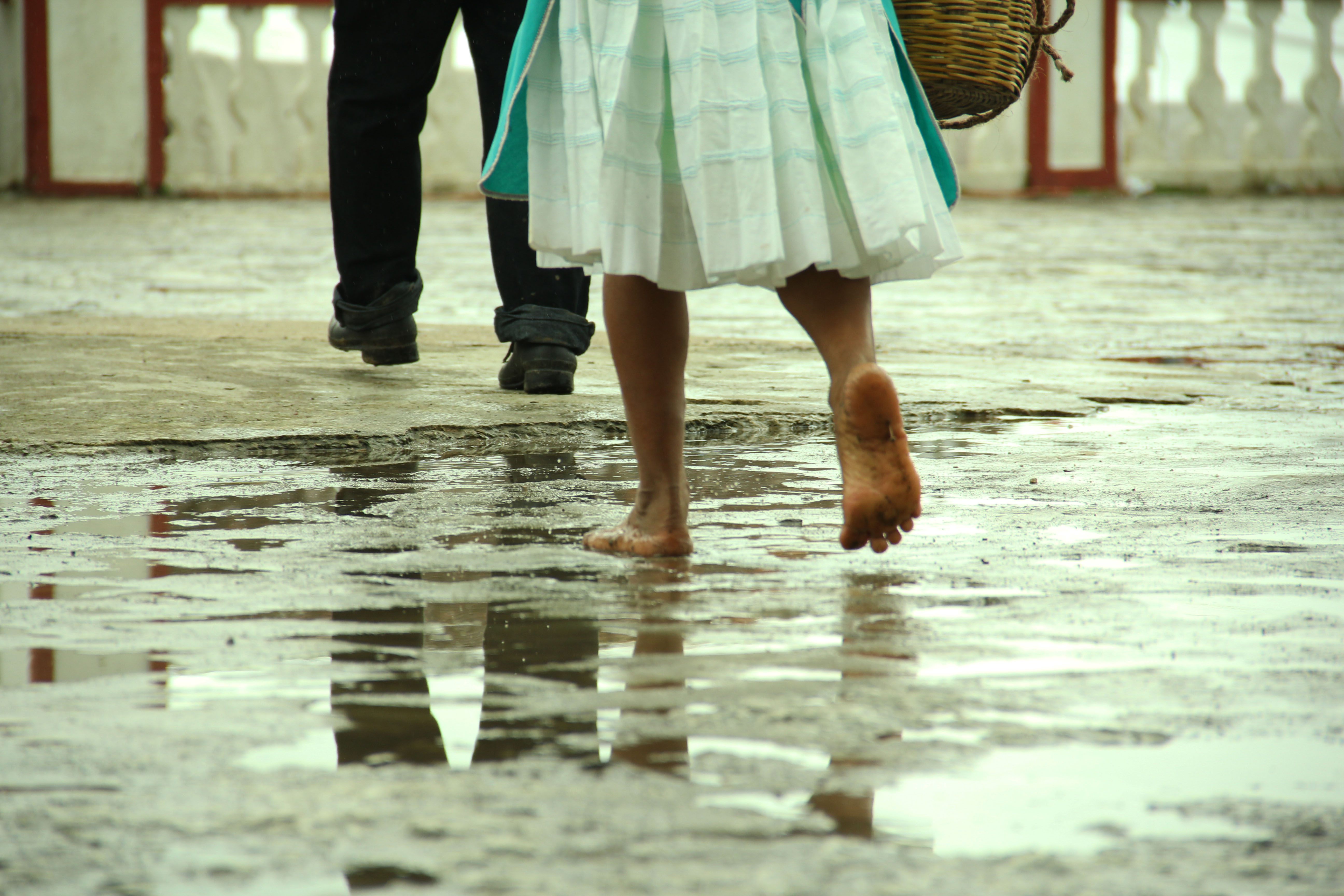 Barefoot woman walking behind her husband as a sign of respect. Sometimes the customs of certain cultures surpass human rights.