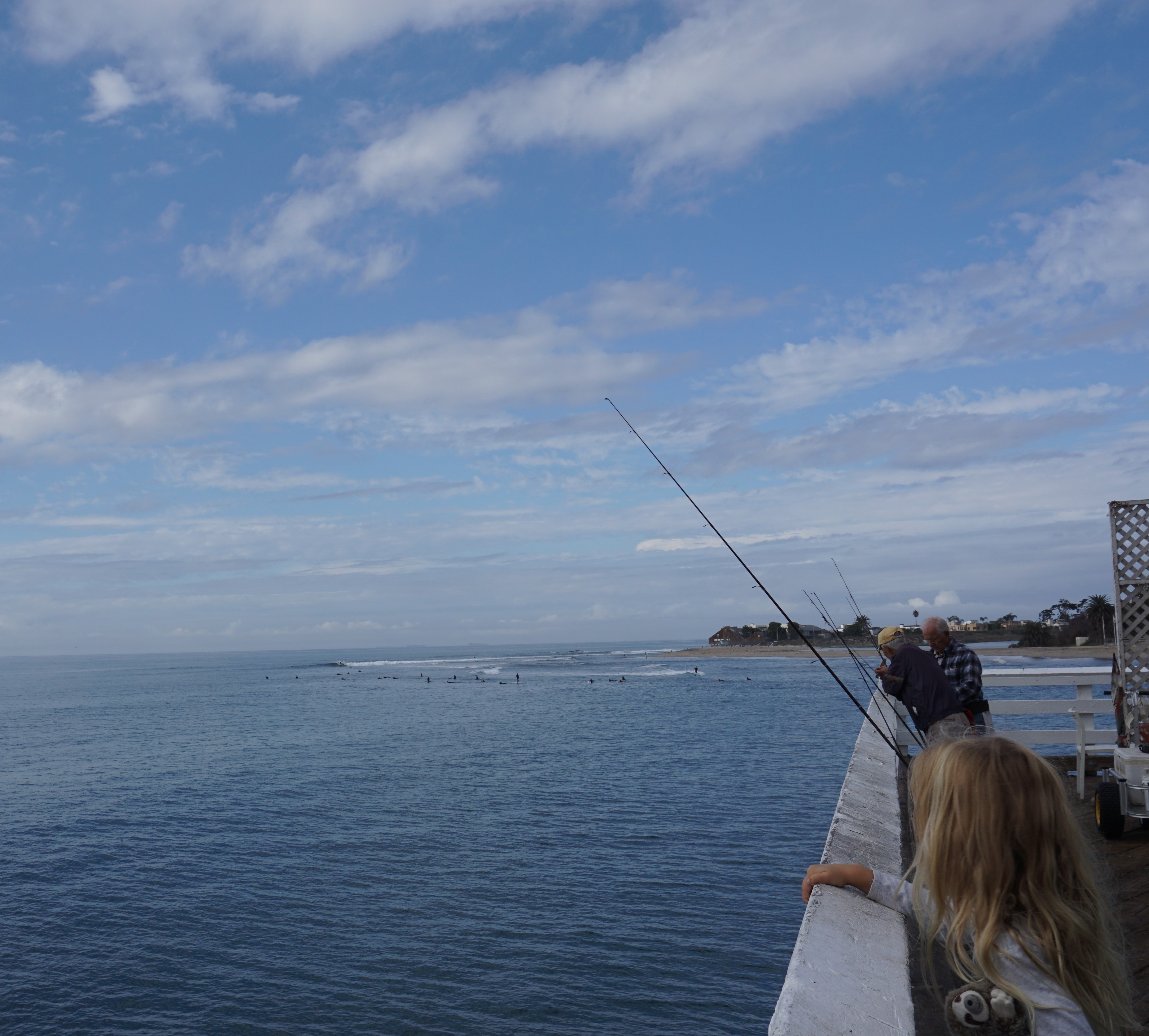 An early morning on the Malibu Pier calls for local fisherman hoping to get a catch for the day while enjoying the breathtaking view of the Pacific Ocean. In the distance you can see the crowd of surfers looking to catch their next wave. 