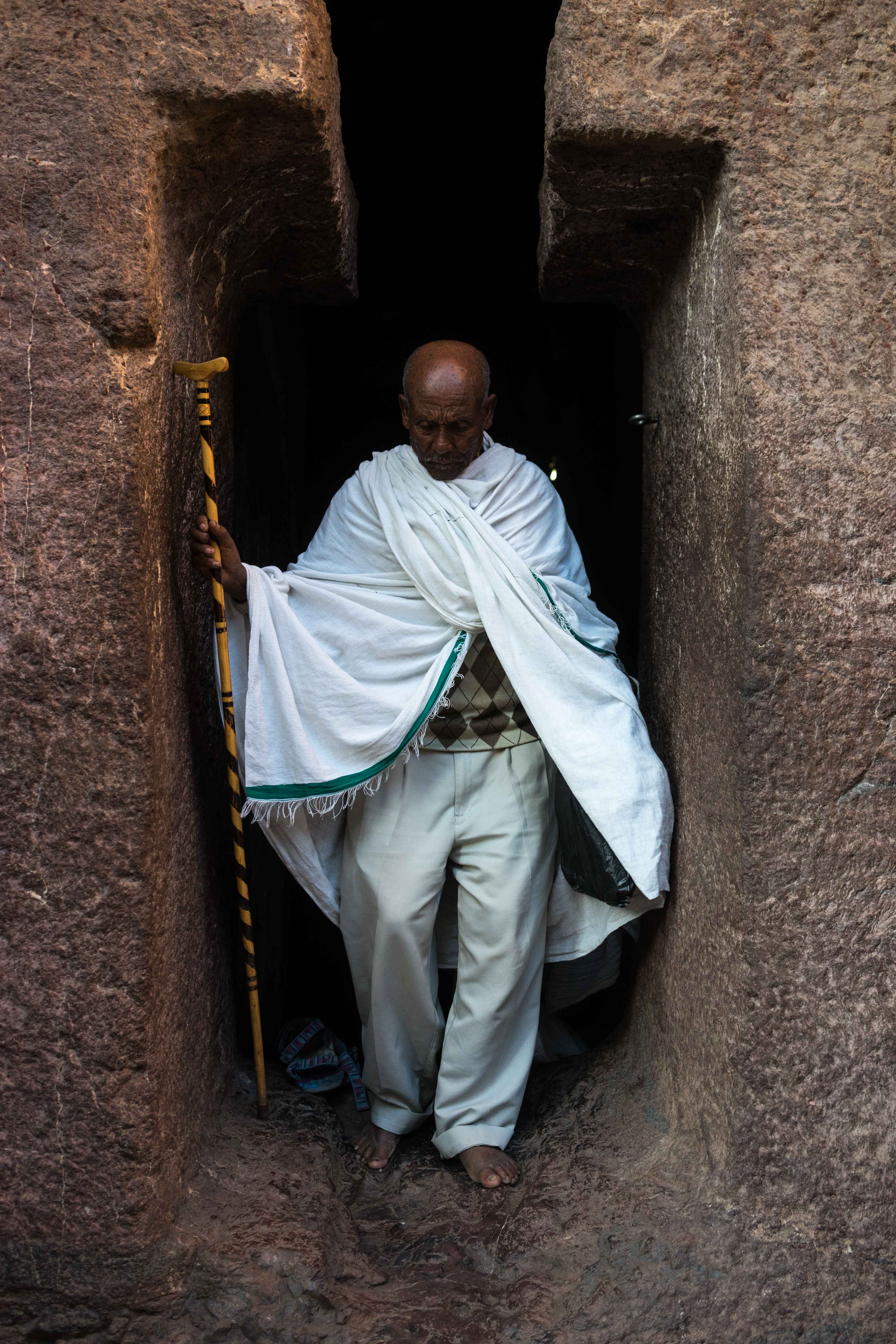 A pilgrim navigates Lalibela's narrow complex of hand-carved churches.