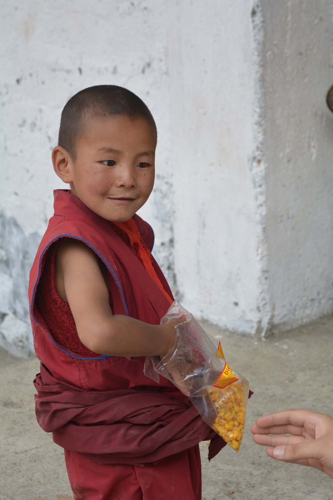 A packet of Diet Namkeen (Salty Snack) brought a smile on this little monk's face