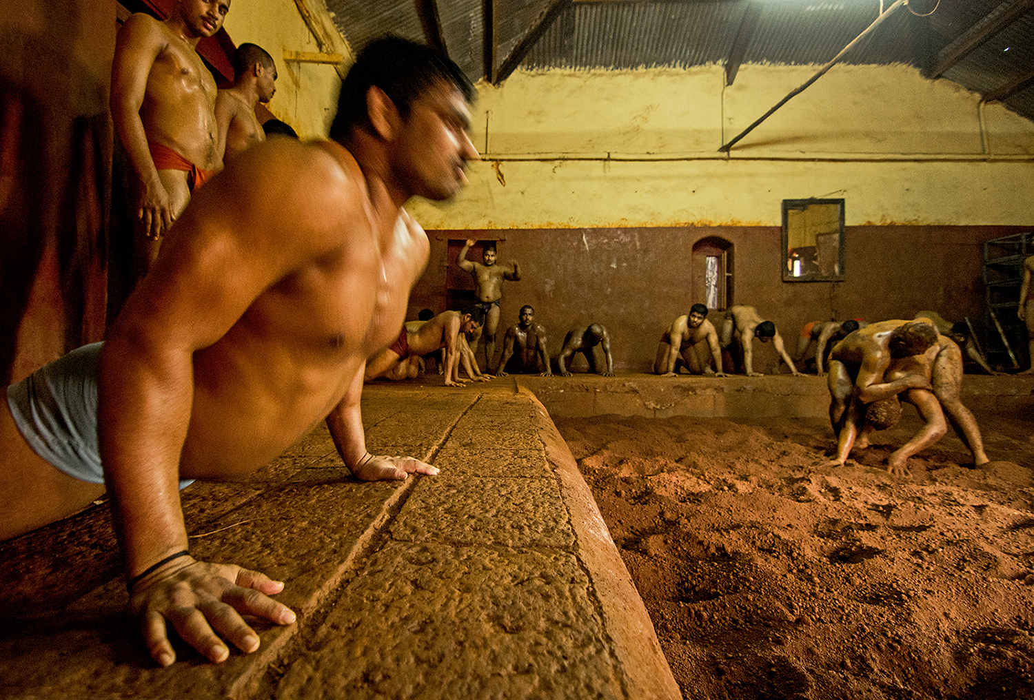 They have 2 training sessions everyday. 3 pairs of wrestlers get on the mud to practice at the same time while the rest of them engage in work outs. They take turns to get on the mud