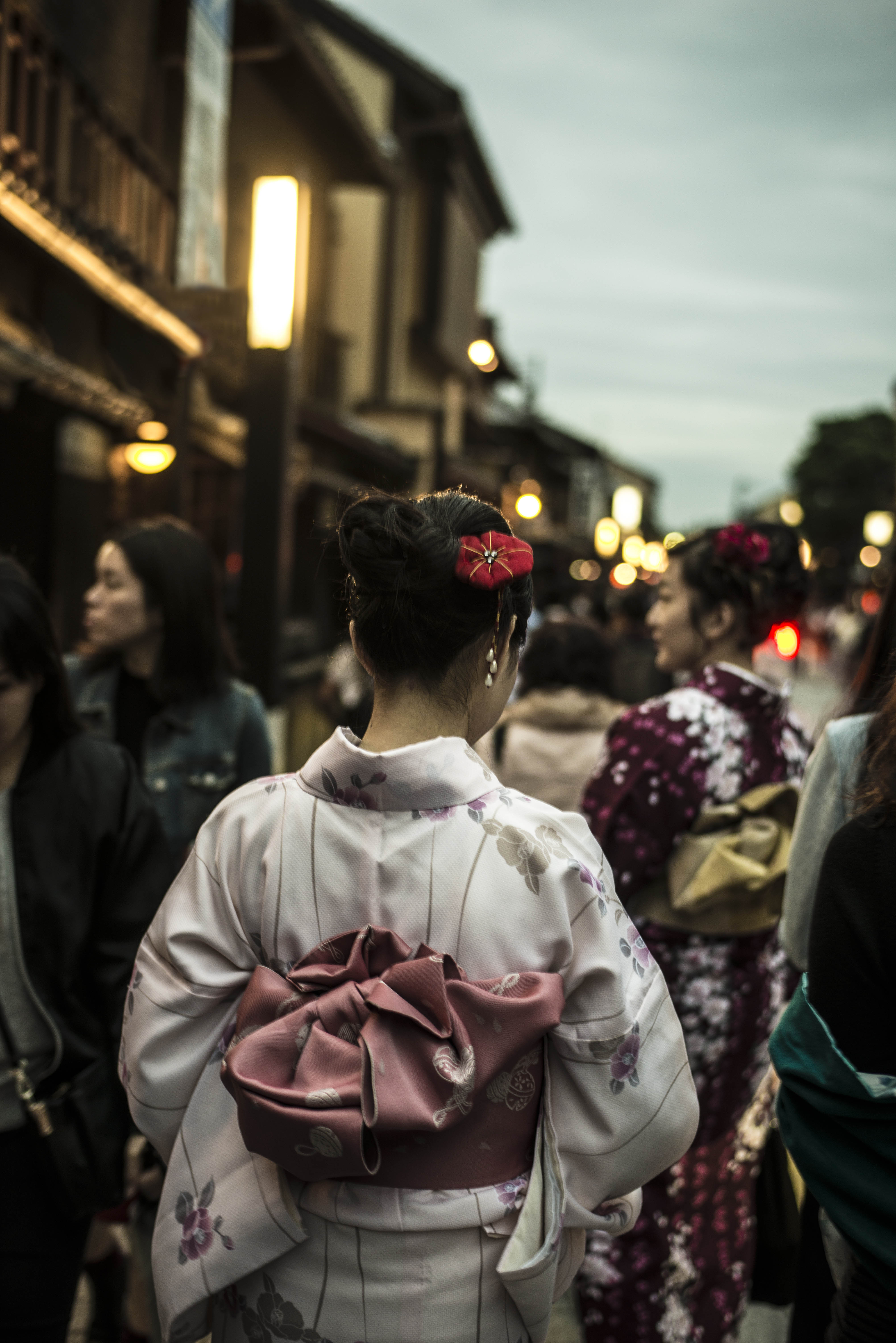 The Gion district of Kyoto finds a mingling of geishas and young women playing dress-up in the traditional kimono and headpiece.