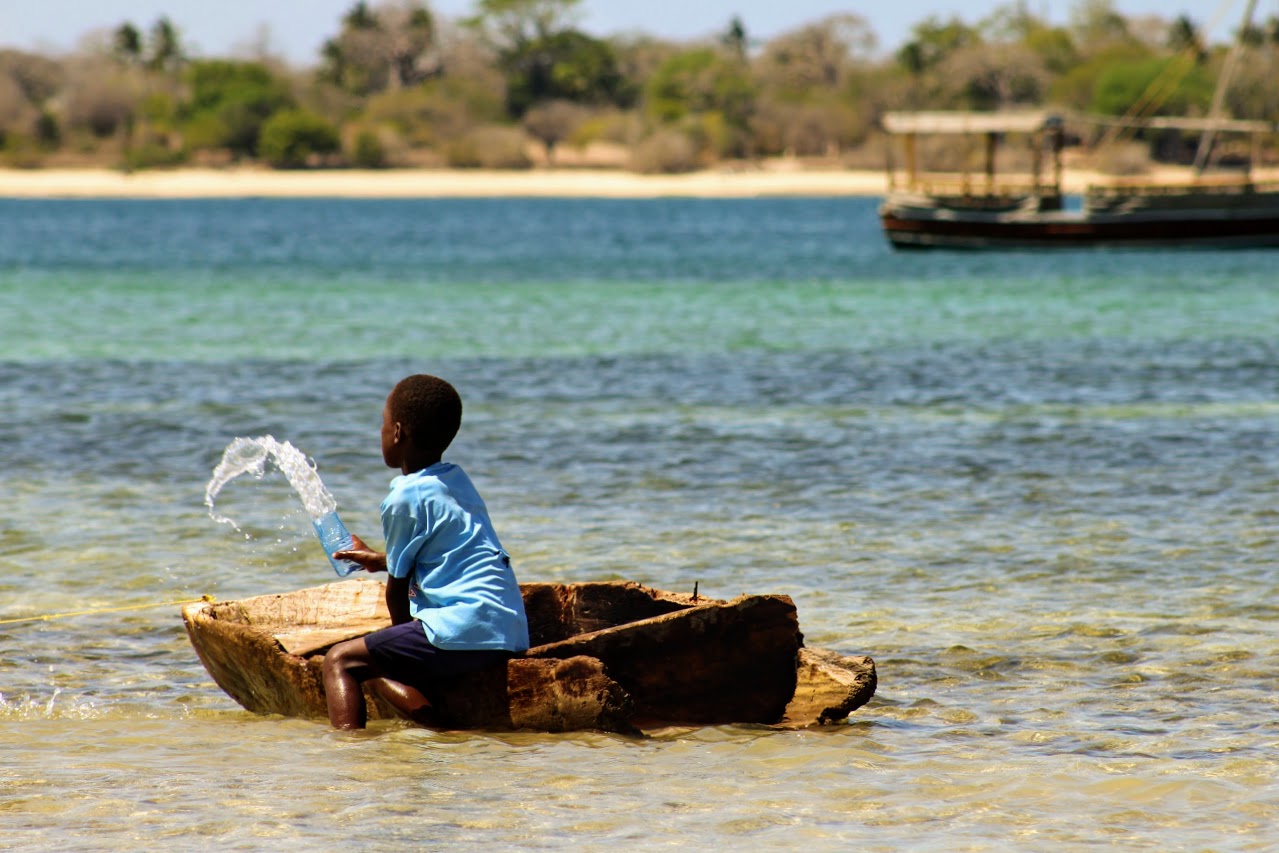 As the subtle flow from the Indian Ocean begins to rise, the determined island juvenile periodically scoops out water from his makeshift boat. 