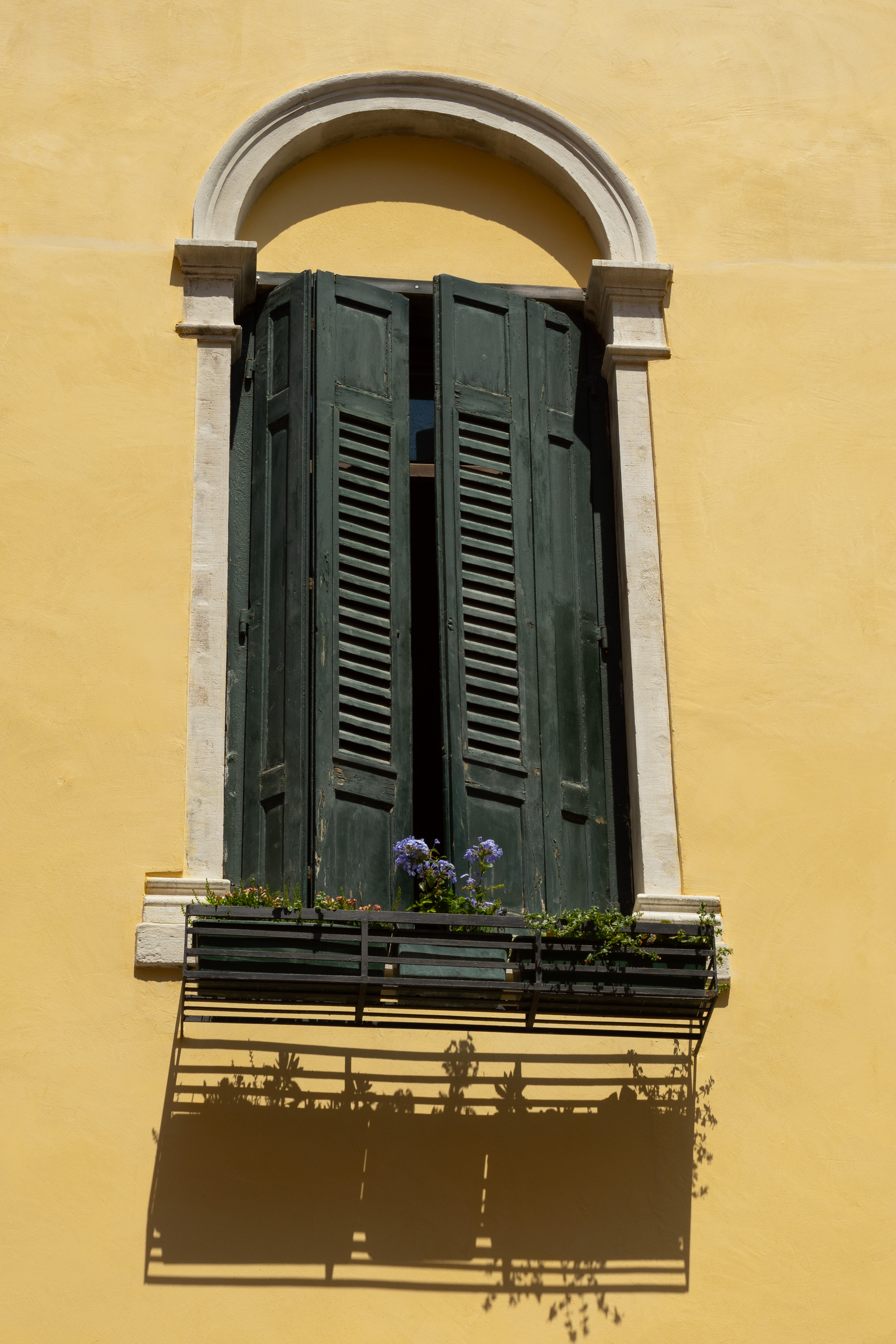 Balcony with flowers at middle of the day, Italy