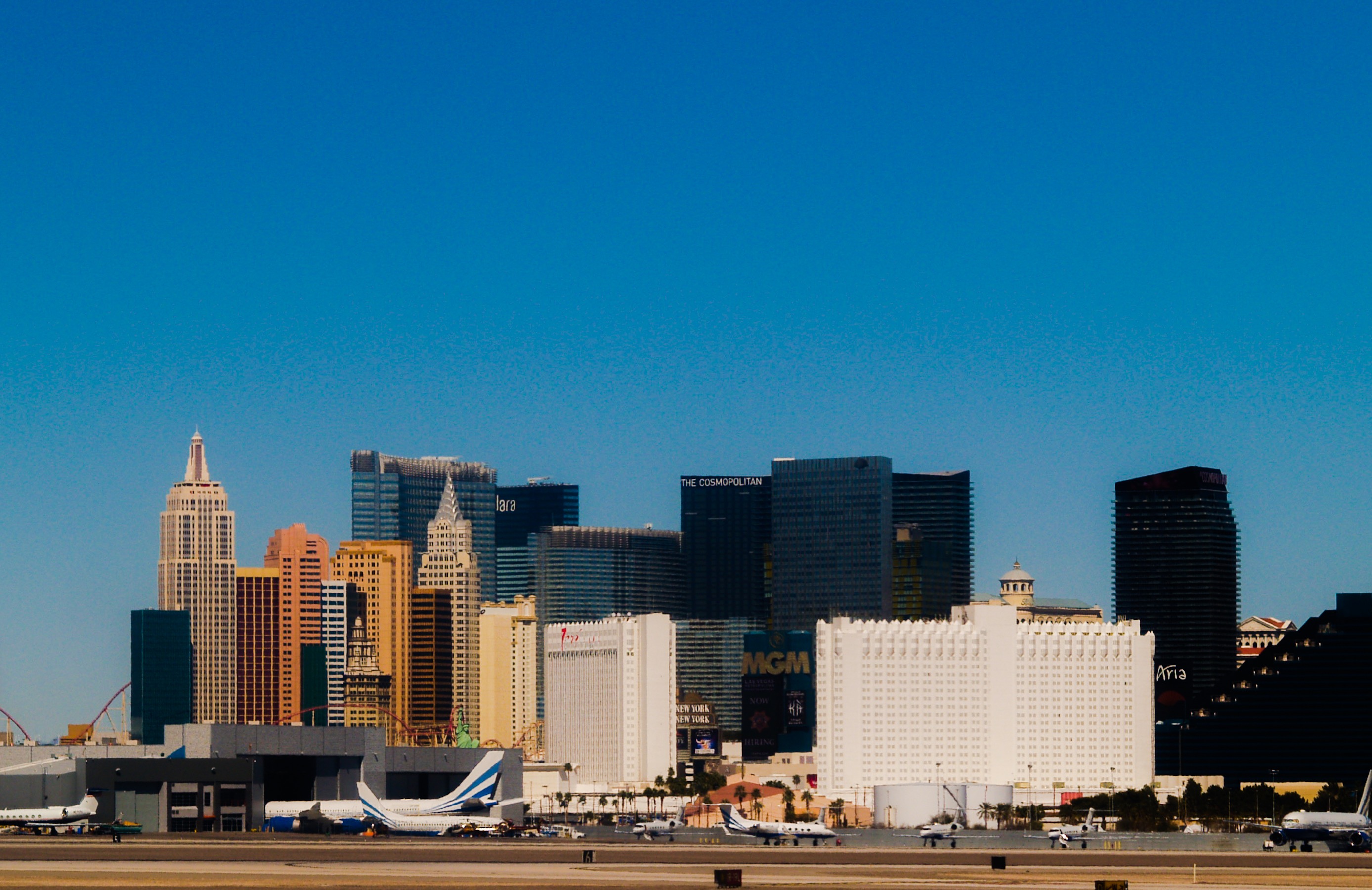 A crisp and cloudless, blue sky overlooking the wonderful Las Vegas skyline, photo was taken leaving the airport from the plane window.