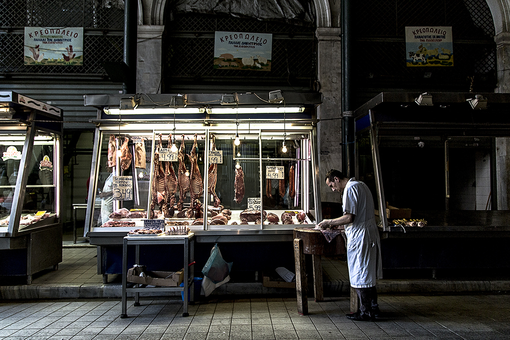 A butcher works at his meat stall in Athens Central Meat and Fish Market. Greek dishes are very meat based, specially lamb. 
