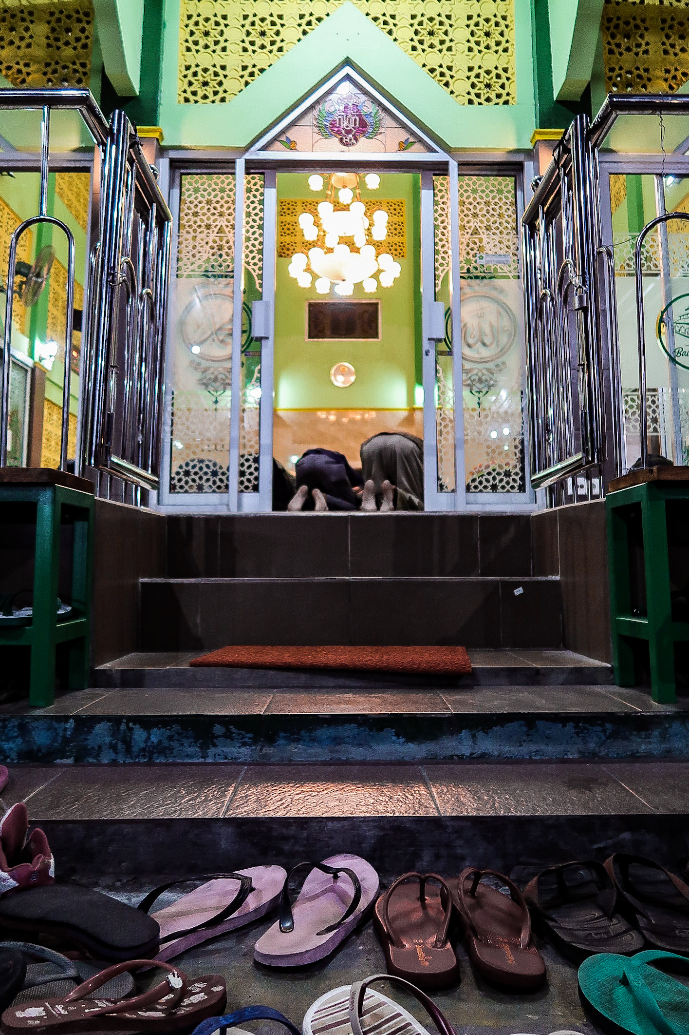 Muslims praying during Ramadan - Indonesia. The geometry dragged me in. The stair work like the headline (connection) from flip flops to the prayers.