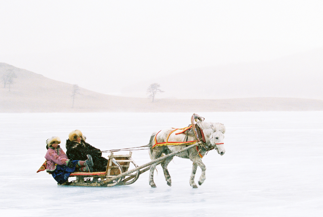 Despite the icy wind, a couple from the Hövsgöl province is looking for tourists to offer them a horse sleigh ride.