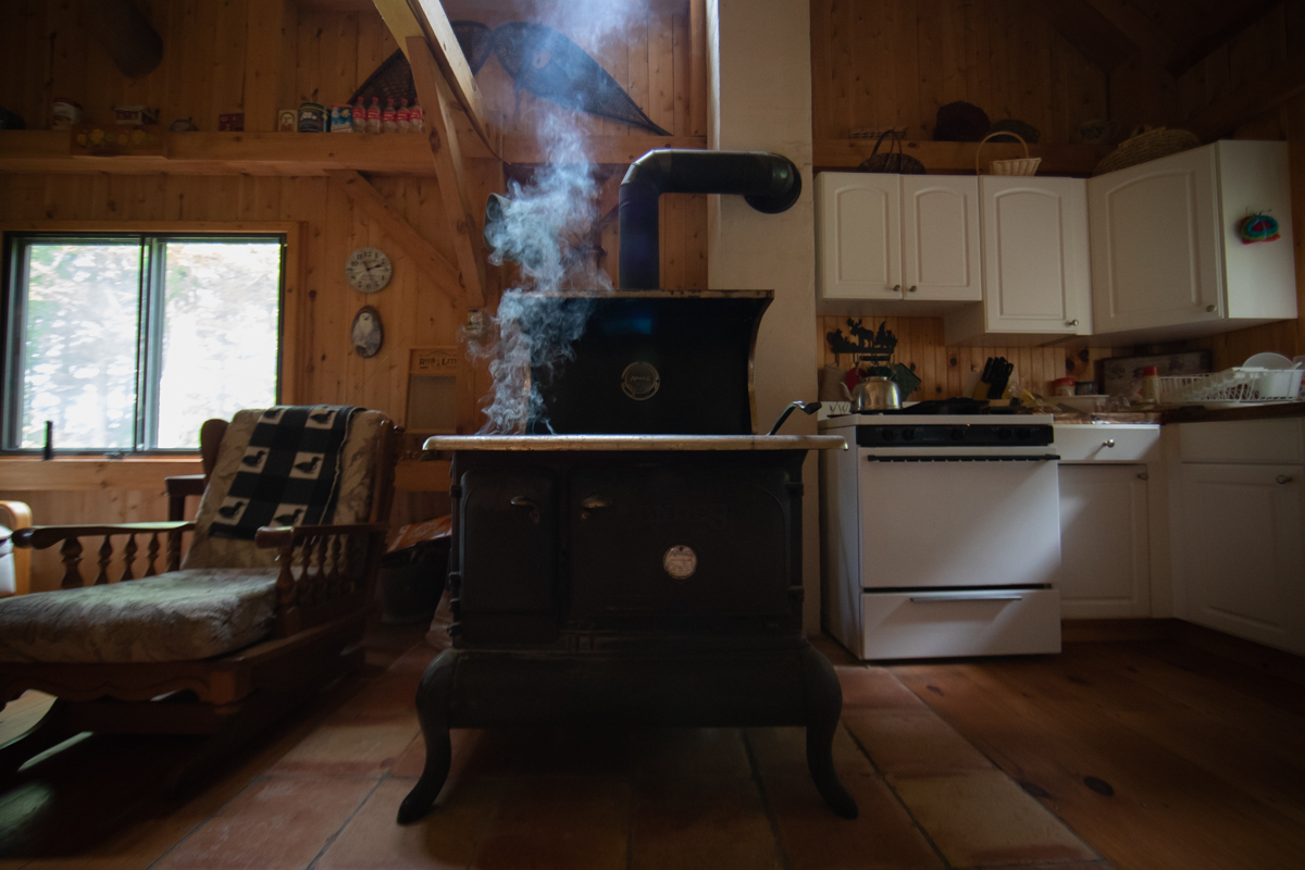 A smoking stove that is used to heat the small cabin in the woods. 