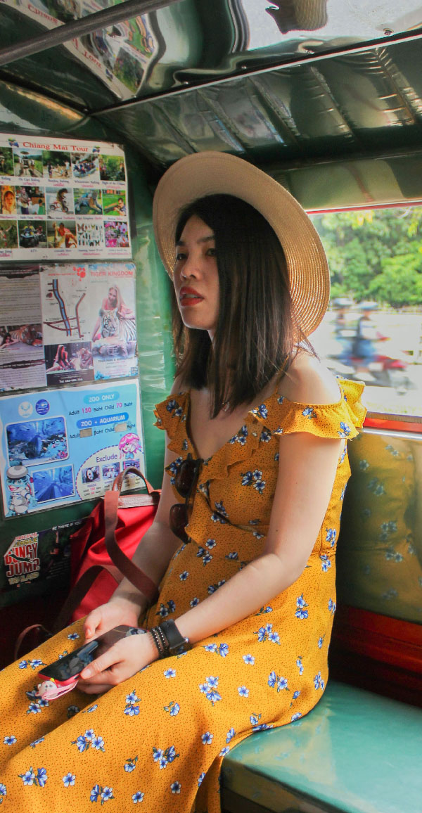 This girl in a sundress and I rode a taxi towards a mountain that guarded Wat Phra That Doi Suthep, a breathtaking golden temple founded in 1383. This image is one that could be analyzed for hours, from the motorcyclists in the background to the cat figurine resting on her phone.
