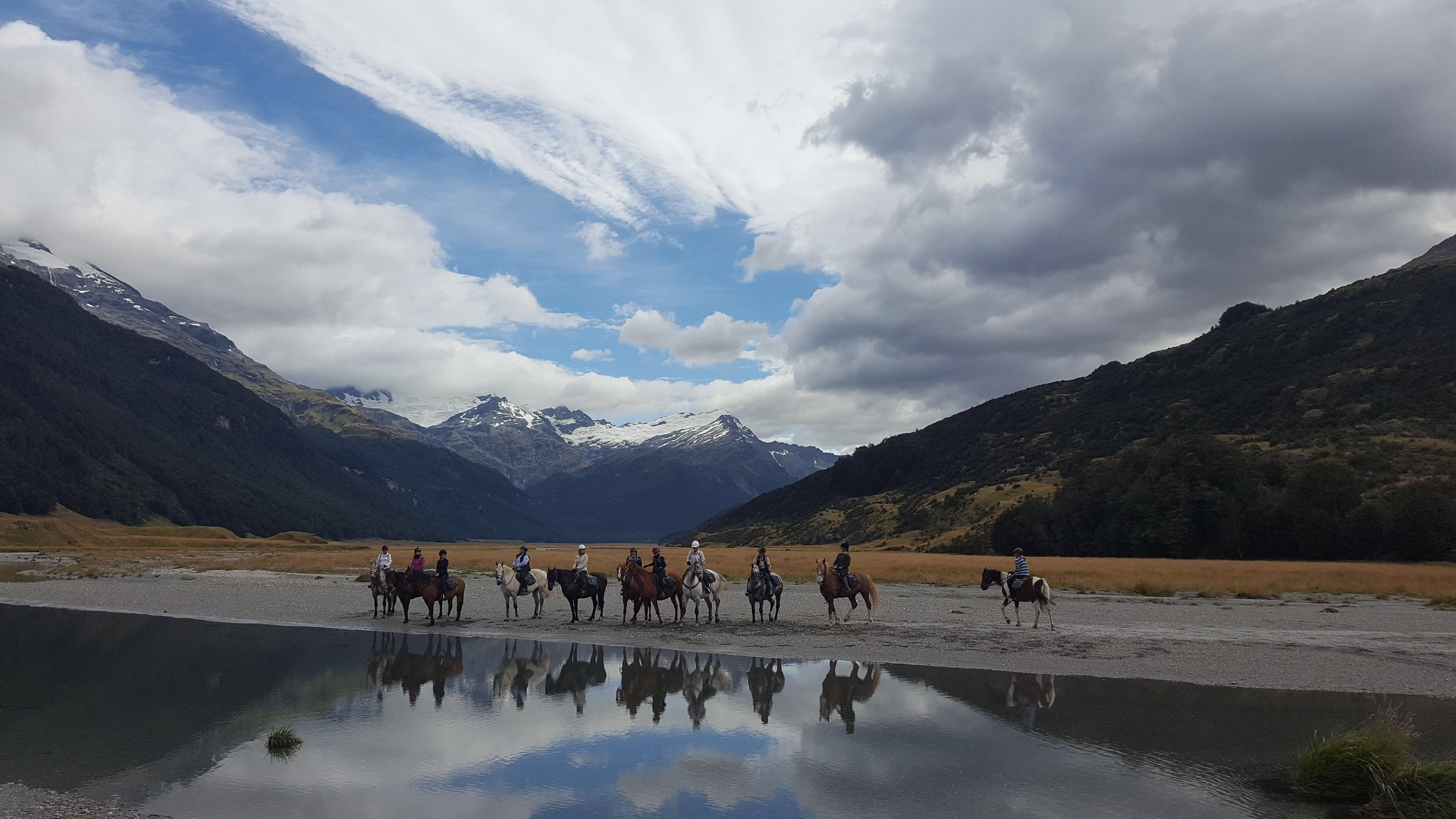 Our group of riders on this amazing ride to Glenorchy, New Zealand. We had to follow the leader across the waters to other side in case one of us got stuck in the quick sand. All went well and no one got stuck in the mud. 